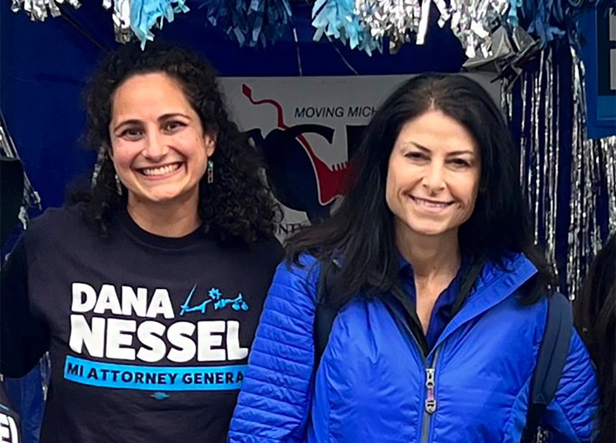 In this photo released by Kimberly Bush, Samantha Woll, left, poses with Michigan Attorney General Dana Nessel on Sept. 4, 2022, in Royal Oak, Mich. Woll, who worked on Nessel’s 2022 campaign, was found stabbed to death outside her home in Detroit on Saturday, Oct. 21, 2023. Woll was the president of the Isaac Agree Downtown Synagogue. (Kimberly Bush via AP)