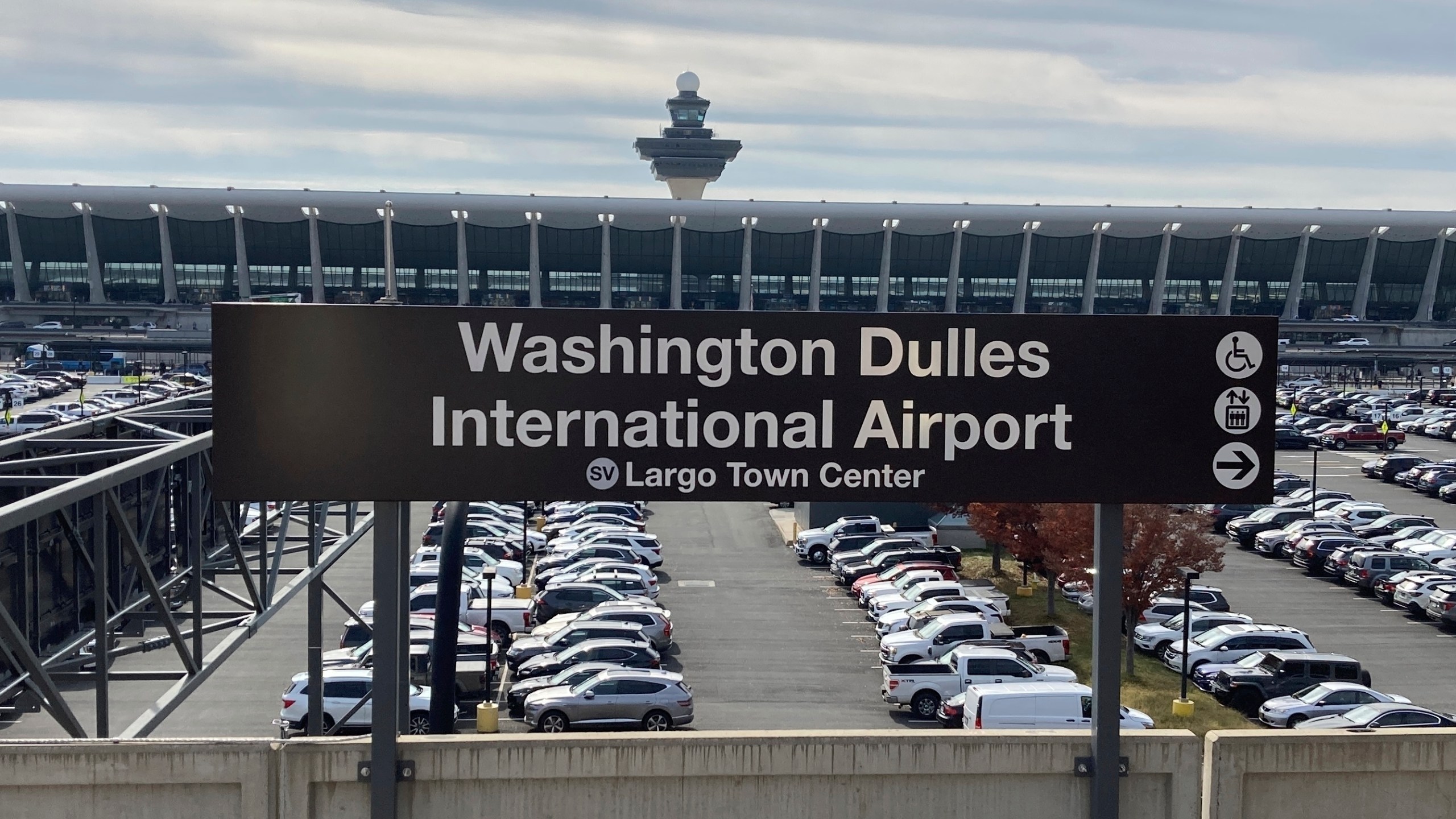 FILE - The terminal at Dulles International Airpor stands behind a Metrorail station sign, Nov. 2, 2022, in Chantilly, Va. A federal judge on Monday, Oct. 23, 2023, ordered the release of a Maryland man who has been imprisoned for more than four years on charges that he plotted Islamic State-inspired attacks at the airport and at a shopping and entertainment complex in the Washington, D.C., area. (AP Photo/Matthew Barakat, File)