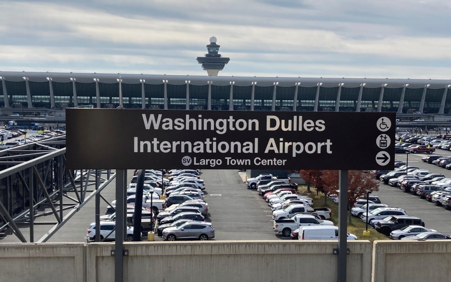 FILE - The terminal at Dulles International Airpor stands behind a Metrorail station sign, Nov. 2, 2022, in Chantilly, Va. A federal judge on Monday, Oct. 23, 2023, ordered the release of a Maryland man who has been imprisoned for more than four years on charges that he plotted Islamic State-inspired attacks at the airport and at a shopping and entertainment complex in the Washington, D.C., area. (AP Photo/Matthew Barakat, File)