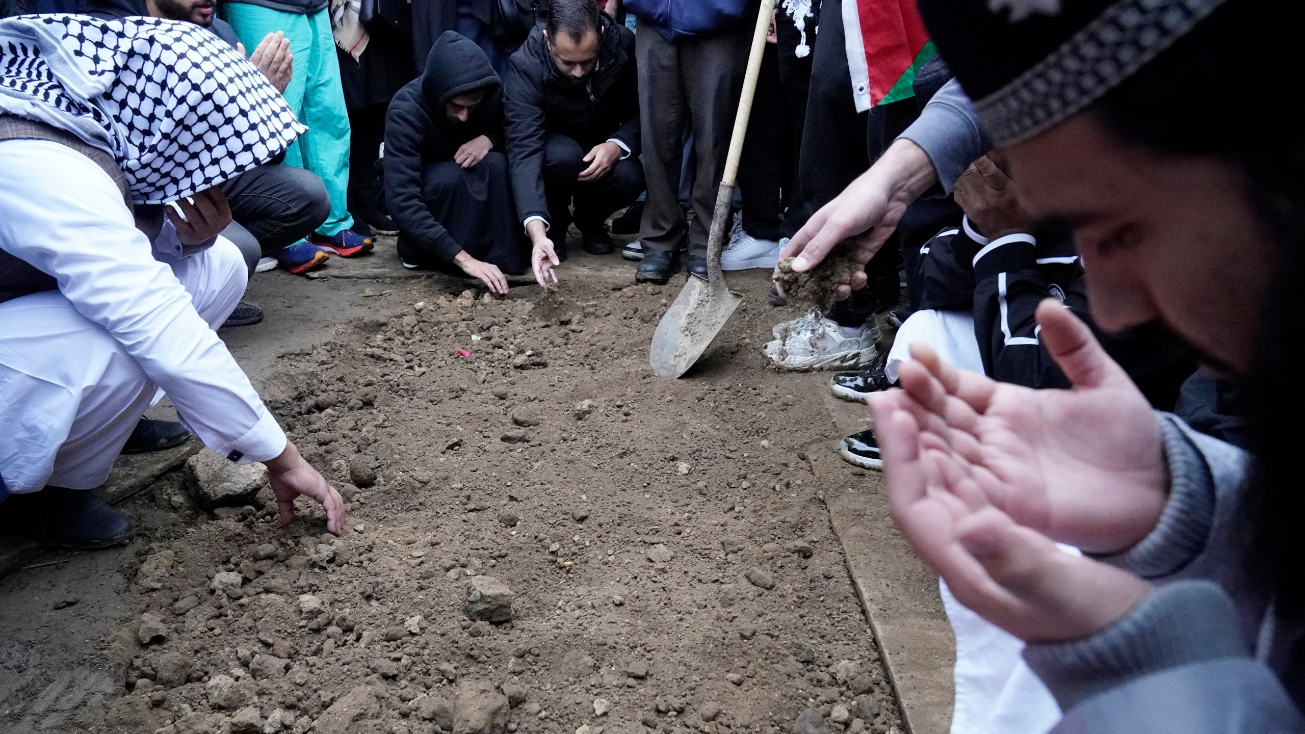 FILE - Muslim community members mourn Wadea Al Fayoume at his grave in LaGrange, Ill., Oct. 16, 2023. A Palestinian-American woman seriously injured in a suspected hate crime that left her 6-year-old son dead in a suburb of Chicago is asking the public to “pray for peace” as she recuperates from her injuries. Hanaan Shahin issued a statement Tuesday, Oct. 24, 2023 through the Chicago chapter of the Council on American-Islamic Relations after meeting with the group’s executive director a day earlier. It marked her first public comments since the brutal Oct. 14 attack that left her with multiple stab wounds and stitches on her face. (AP Photo/Nam Y. Huh, file)