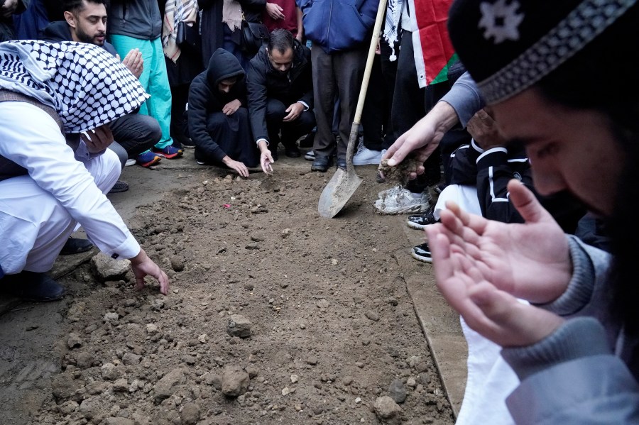 FILE - Muslim community members mourn Wadea Al Fayoume at his grave in LaGrange, Ill., Oct. 16, 2023. A Palestinian-American woman seriously injured in a suspected hate crime that left her 6-year-old son dead in a suburb of Chicago is asking the public to “pray for peace” as she recuperates from her injuries. Hanaan Shahin issued a statement Tuesday, Oct. 24, 2023 through the Chicago chapter of the Council on American-Islamic Relations after meeting with the group’s executive director a day earlier. It marked her first public comments since the brutal Oct. 14 attack that left her with multiple stab wounds and stitches on her face. (AP Photo/Nam Y. Huh, file)