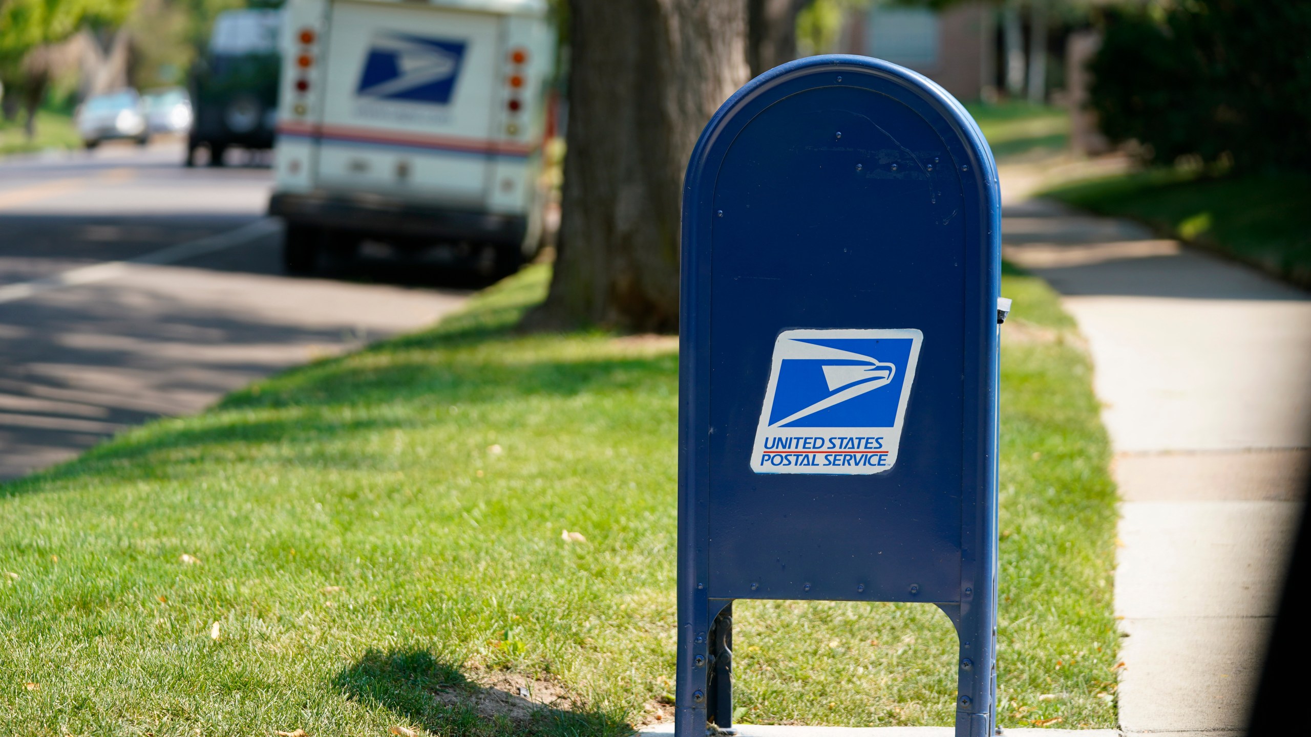 FILE - A United States Postal Service mailbox stands along Bonnie Brae Boulevard Monday, Aug. 17, 2020, in southeast Denver. The U.S. Postal Service says law enforcement officials have charged more than 600 people with postal crimes since launching a crackdown in May. The so-called “Operation Safe Delivery” follows a surge in robberies. (AP Photo/David Zalubowski, file)