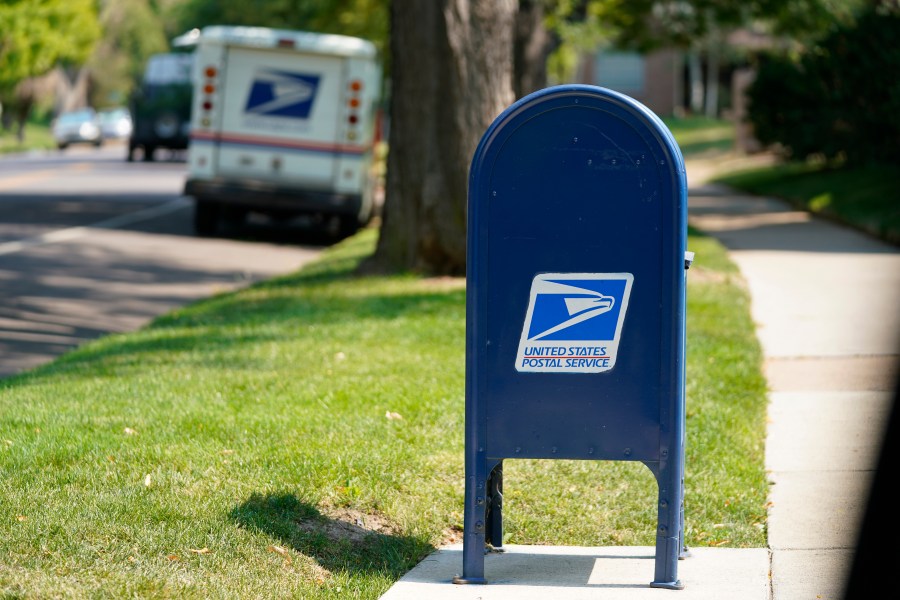 FILE - A United States Postal Service mailbox stands along Bonnie Brae Boulevard Monday, Aug. 17, 2020, in southeast Denver. The U.S. Postal Service says law enforcement officials have charged more than 600 people with postal crimes since launching a crackdown in May. The so-called “Operation Safe Delivery” follows a surge in robberies. (AP Photo/David Zalubowski, file)