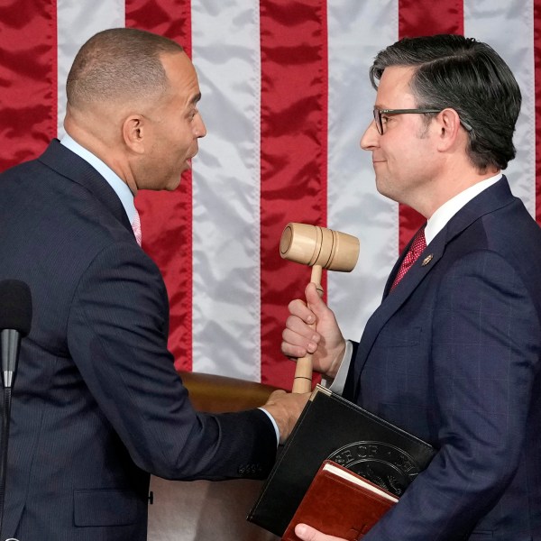 House Minority Leader Hakeem Jeffries of N.Y., hands the gavel to speaker-elect Rep. Mike Johnson, R-La., at the Capitol in Washington, Wednesday, Oct. 25, 2023. (AP Photo/Alex Brandon)