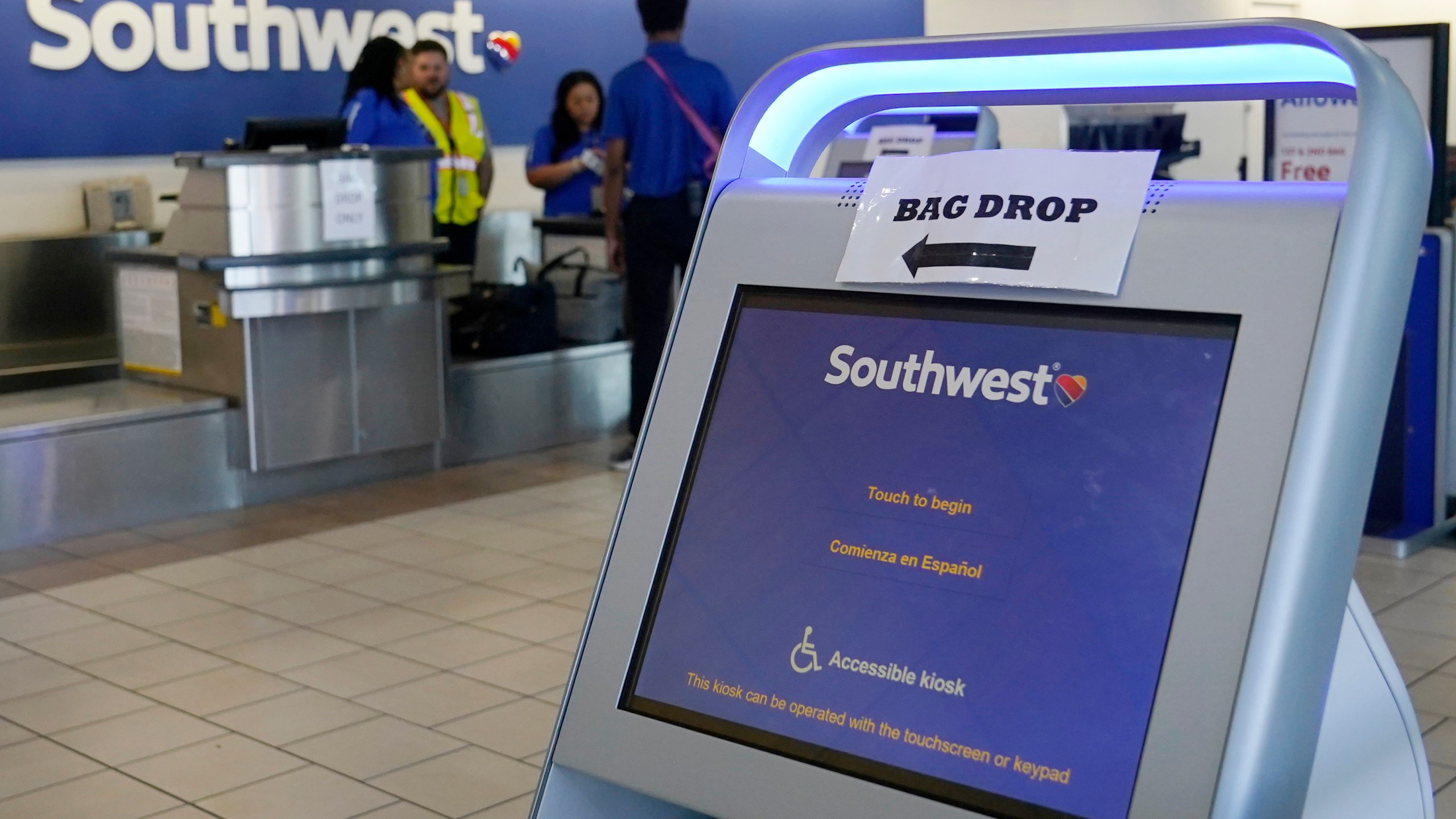 FILE - Employees stand by an empty Southwest Airlines ticket counter Tuesday, April 18, 2023, in Oklahoma City. Southwest Airlines reports earnings on Thursday, Oct. 26, 2023 (AP Photo/Sue Ogrocki, File)