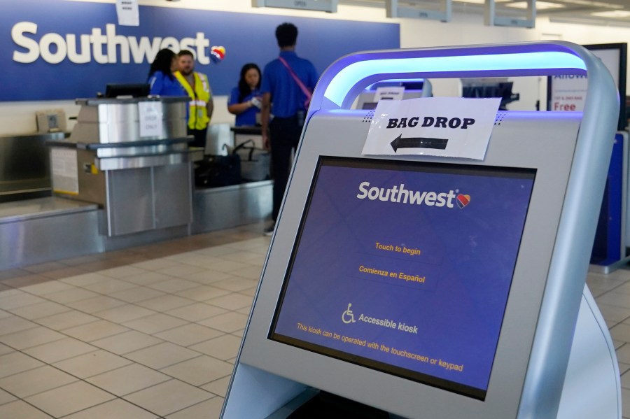 FILE - Employees stand by an empty Southwest Airlines ticket counter Tuesday, April 18, 2023, in Oklahoma City. Southwest Airlines reports earnings on Thursday, Oct. 26, 2023 (AP Photo/Sue Ogrocki, File)