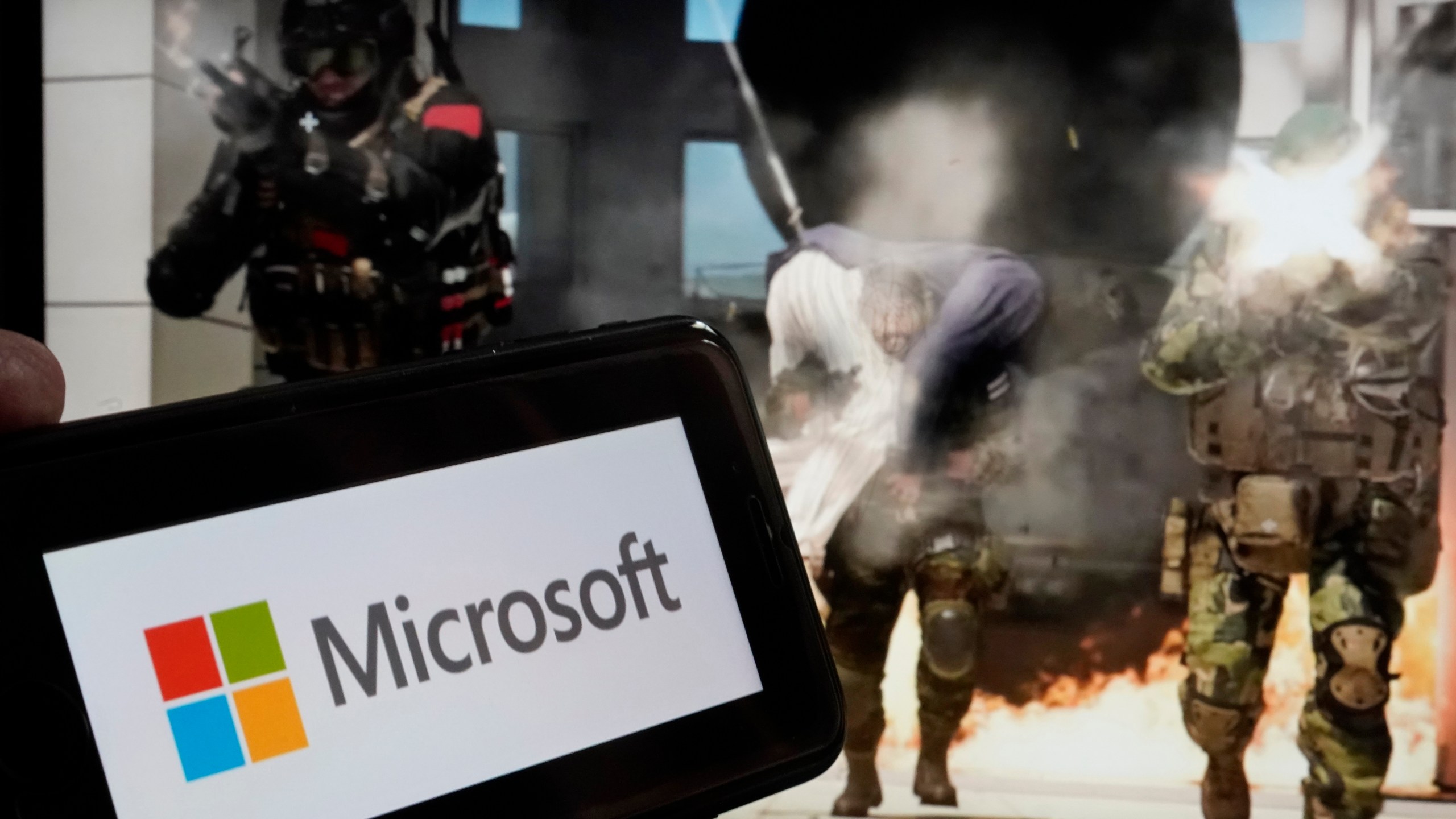 FILE - The logo for Microsoft, and a scene from Activision "Call of Duty - Modern Warfare," are shown in this photo, in New York, Wednesday, June 21, 2023. Microsoft reports earnings on Tuesday, Oct. 24, 2023. (AP Photo/Richard Drew, File)