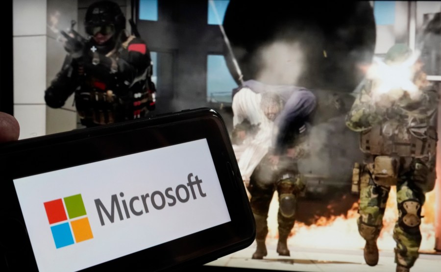 FILE - The logo for Microsoft, and a scene from Activision "Call of Duty - Modern Warfare," are shown in this photo, in New York, Wednesday, June 21, 2023. Microsoft reports earnings on Tuesday, Oct. 24, 2023. (AP Photo/Richard Drew, File)