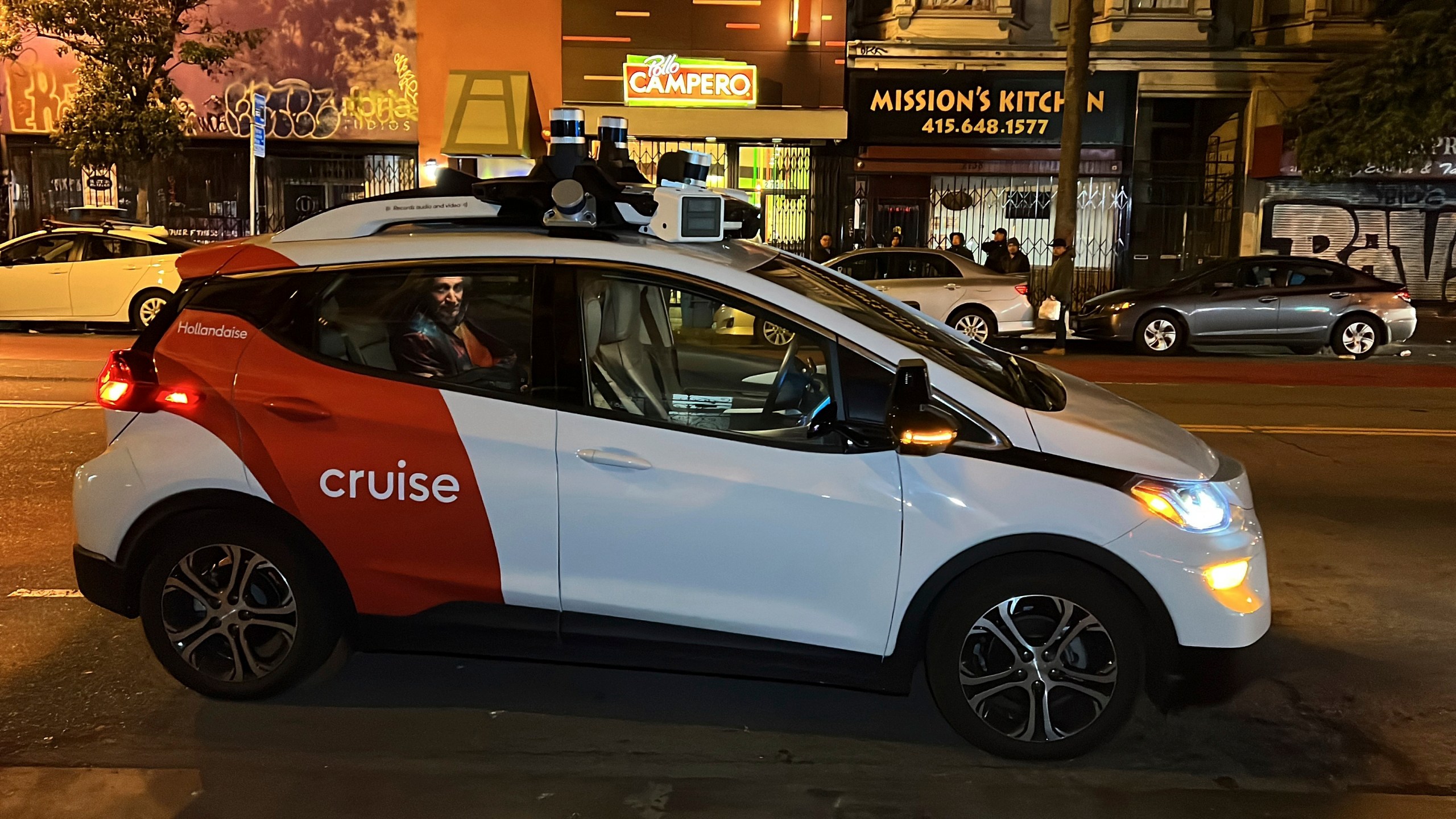 FILE - Associated Press reporter Michael Liedtke sits in the back of a Cruise driverless taxi that picked him up in San Francisco's Mission District, Feb. 15, 2023. California's Department of Motor Vehicles on Tuesday, Oct. 24, immediately suspended operation of Cruise's driverless robotaxis in San Francisco, citing public safety after one of its cars ran over a person fatally struck by a vehicle driven by a human. (AP Photo/Terry Chea, File)