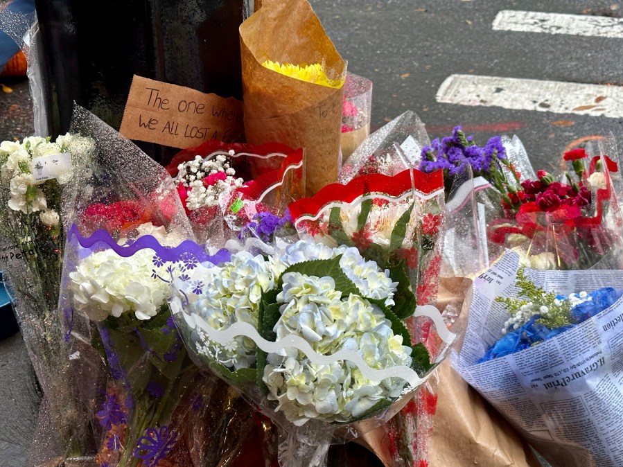 A makeshift memorial for Matthew Perry is seen outside the building known as the "Friends" building in New York, Sunday, Oct. 29, 2023. Fans lingered in the rain, taking pictures and leaving flowers on the corner outside the building shown in exterior shots on the popular TV show. Perry, who played Chandler Bing on NBC’s “Friends” for 10 seasons, was found dead at his Los Angeles home on Saturday. He was 54. (AP Photo/Brooke Lansdale)