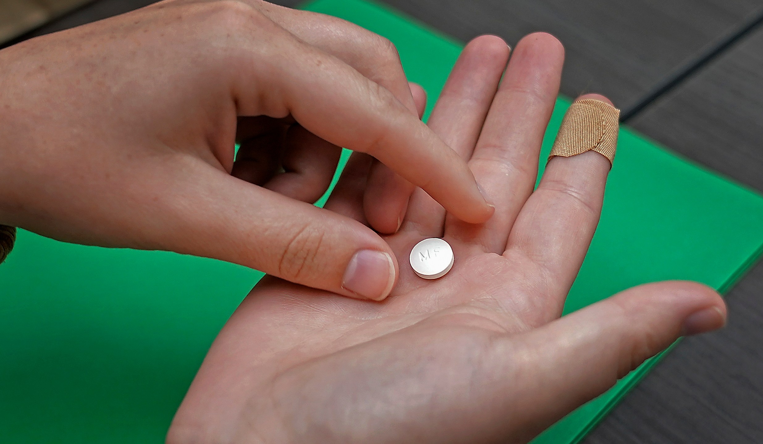 FILE - A patient prepares to take the first of two combination pills, mifepristone, for a medication abortion during a visit to a clinic in Kansas City, Kan., Oct. 12, 2022. On Monday, Oct. 30, 2023, a Kansas judge put a new state law on medication abortions on hold and blocked older restrictions that for years have spelled out what providers must tell patients and forced patients to wait 24 hours to end their pregnancies. (AP Photo/Charlie Riedel, File)