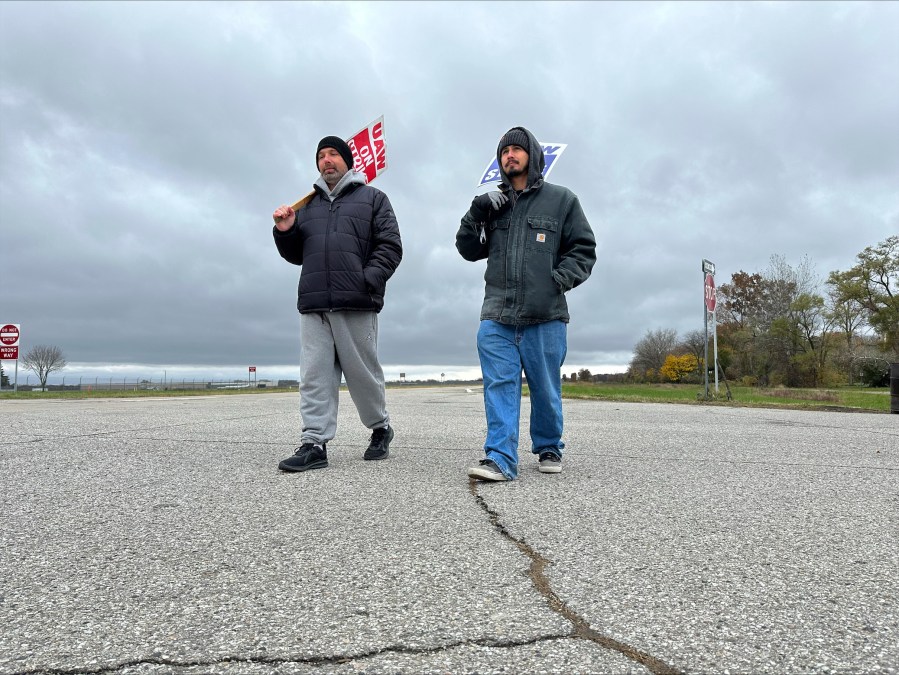 United Auto Workers members walk on the picket line outside a General Motors facility in Van Buren Township, Mich., Monday, Oct. 30, 2023. General Motors and the United Auto Workers union have reached a tentative contract agreement that could end a six-week-old strike against Detroit automakers, two people briefed on the deal said Monday. (AP Photo/Mike Householder)