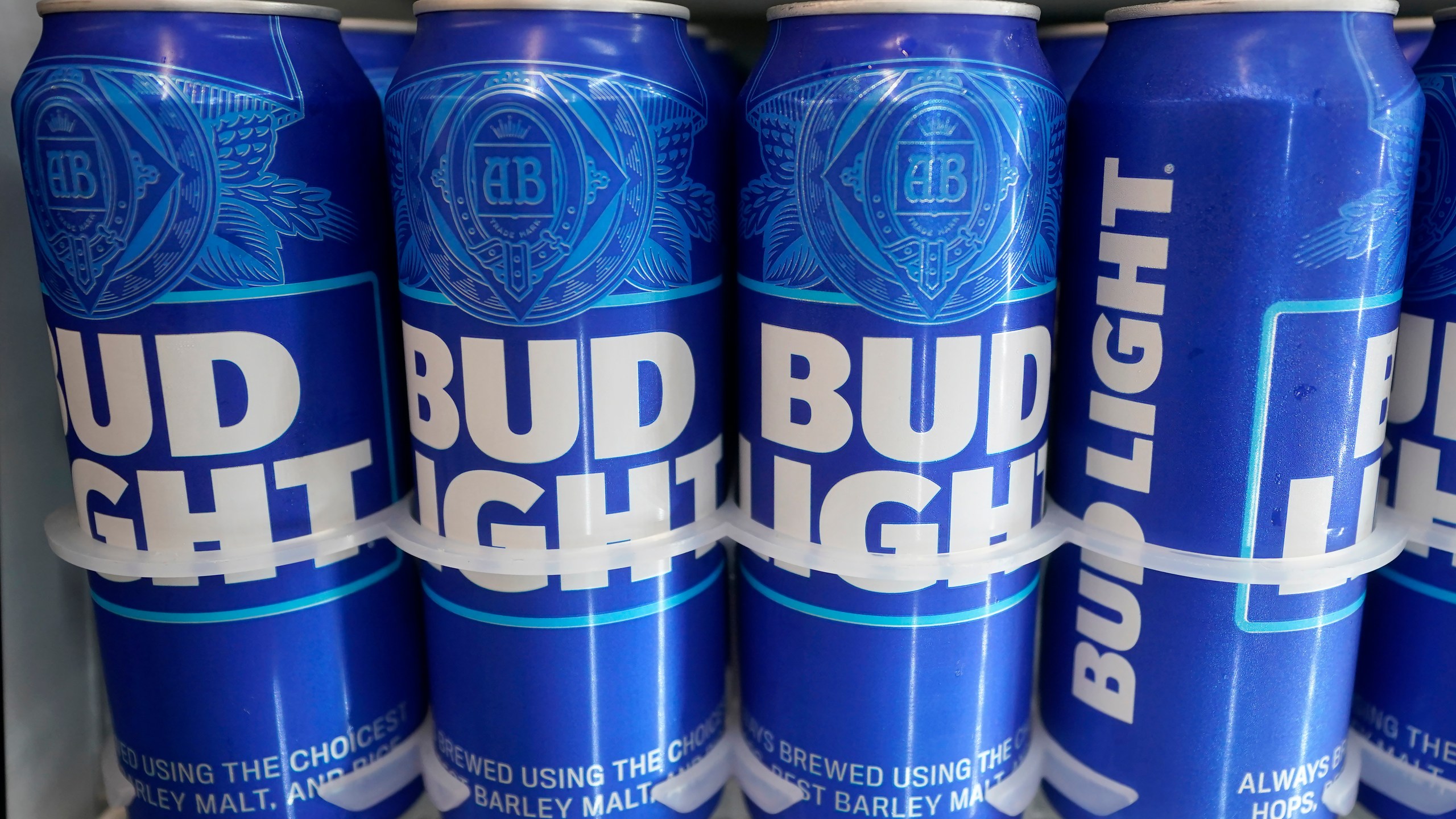 FILE-Cans of Bud Light chill in a refrigerator in Oakland, Calif., Friday, April 28, 2023. AB InBev reports earnings on Tuesday, Oct. 31. (AP Photo/Jeff Chiu)