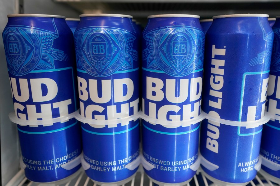 FILE-Cans of Bud Light chill in a refrigerator in Oakland, Calif., Friday, April 28, 2023. AB InBev reports earnings on Tuesday, Oct. 31. (AP Photo/Jeff Chiu)