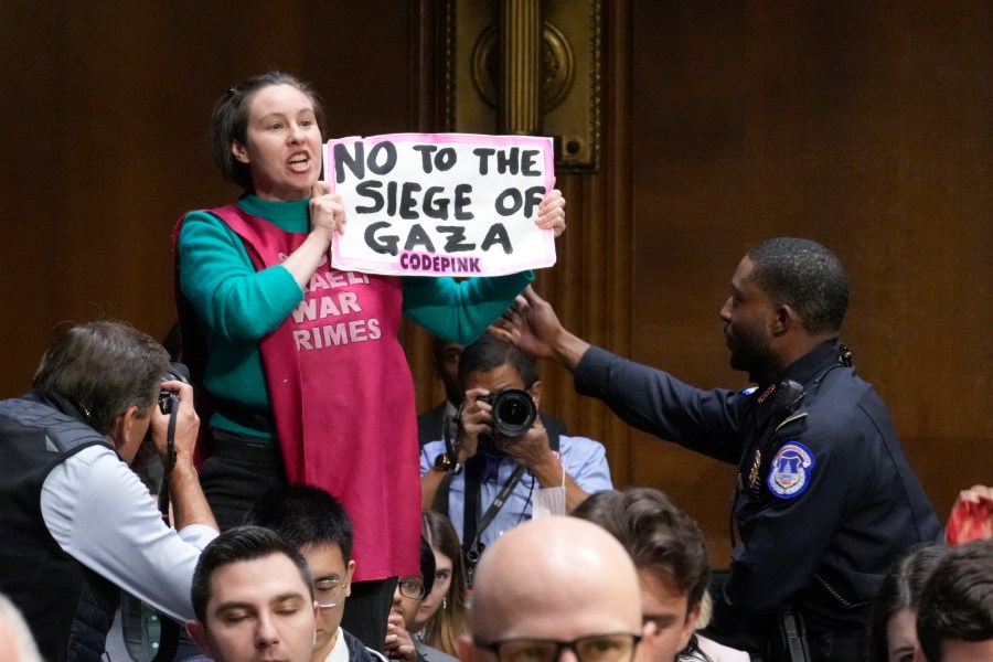 An anti-war activist shouts in protest as Secretary of State Antony Blinken and Defense Secretary Lloyd Austin make the case to the Senate Appropriations Committee that the United States should immediately send aid to Israel and Ukraine, at the Capitol in Washington, Tuesday, Oct. 31, 2023. (AP Photo/J. Scott Applewhite)