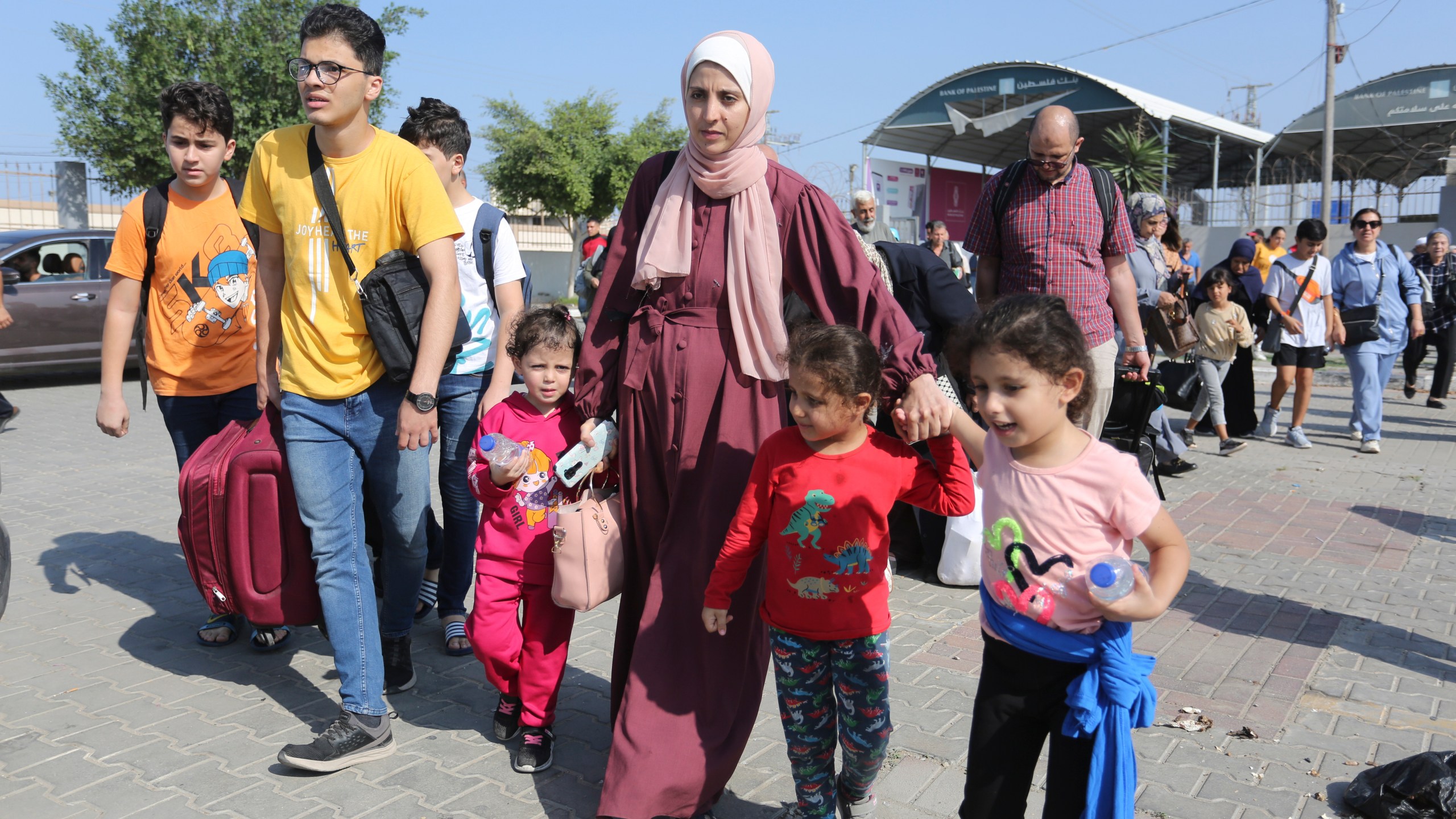 Palestinians cross to the Egyptian side of the border crossing with the Gaza Strip Wednesday, Nov. 1, 2023. in Rafah Wednesday, Nov. 1, 2023. (AP Photo/Hatem Ali)