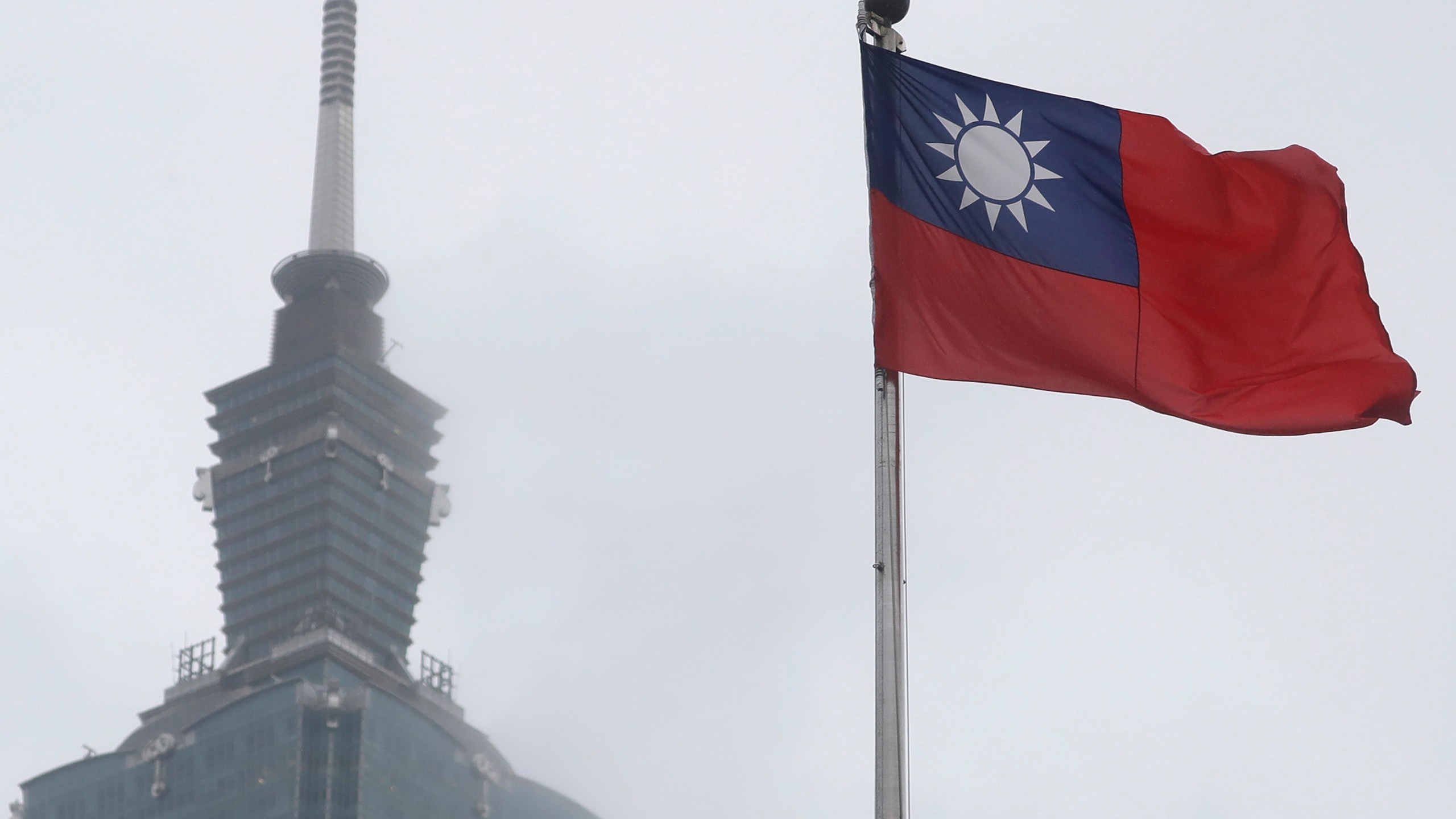 FILE - A Taiwan national flag flutters near the Taipei 101 building at the National Dr. Sun Yat-Sen Memorial Hall in Taipei, Taiwan, on May 7, 2023. Taiwan said Wednesday, Nov. 1, 2023 that China sent 43 military aircraft and seven ships near the self-ruled island, the latest sign that Beijing plans no let-up in its campaign of harassment, threats and intimidation. (AP Photo/Chiang Ying-ying, File)