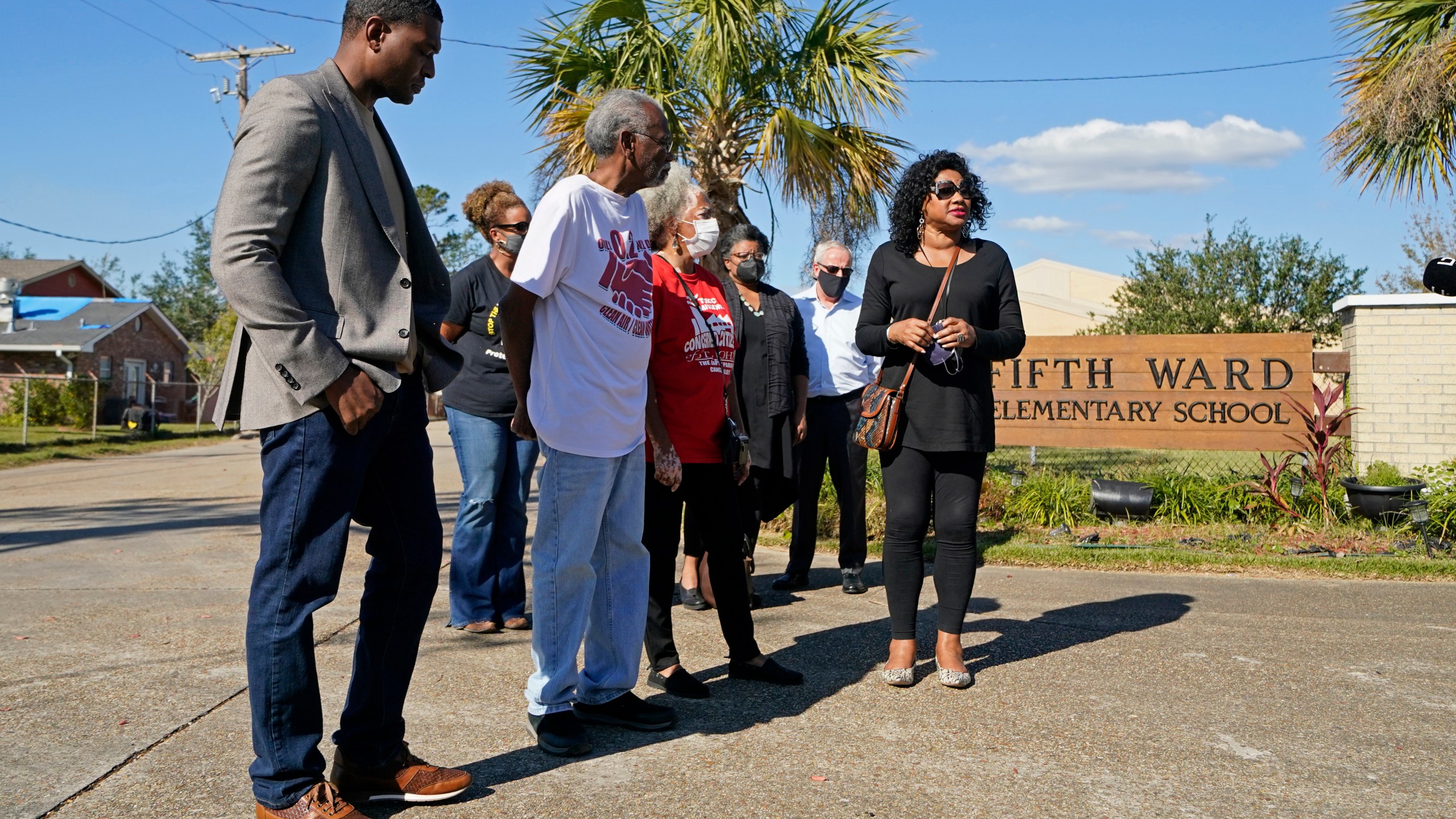 FILE - EPA Administrator Michael Regan, left, arrives at the Fifth Ward Elementary School, which is near the Denka plant, with Robert Taylor, second left, founder of Concerned Citizens of St. John's Parish, and Lydia Gerard, third left, a member of the group, in Reserve, La., Nov. 16, 2021. The Environmental Protection Agency spent more than a year investigating whether Louisiana's oversight of industrial air emissions discriminated against Black residents. The EPA’s investigation ended, however, before it secured commitments from the state to strengthen its oversight. (AP Photo/Gerald Herbert, File)