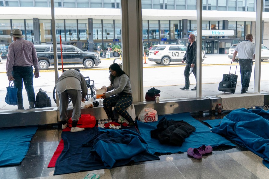 FILE - Run by a private firm hired by the city, migrants stay in a makeshift shelter at O'Hare International Airport, Sept. 20, 2023, in Chicago. Five mayors from around the U.S. want a meeting with President Joe Biden to ask for help controlling the continued arrival of large groups of migrants to their cities. The mayors of Denver, Chicago, Houston, New York and Los Angeles say in a letter to Biden that there has been little to no coordination, support or resources and that is leading to a crisis. (AP Photo/Erin Hooley, File Photo)