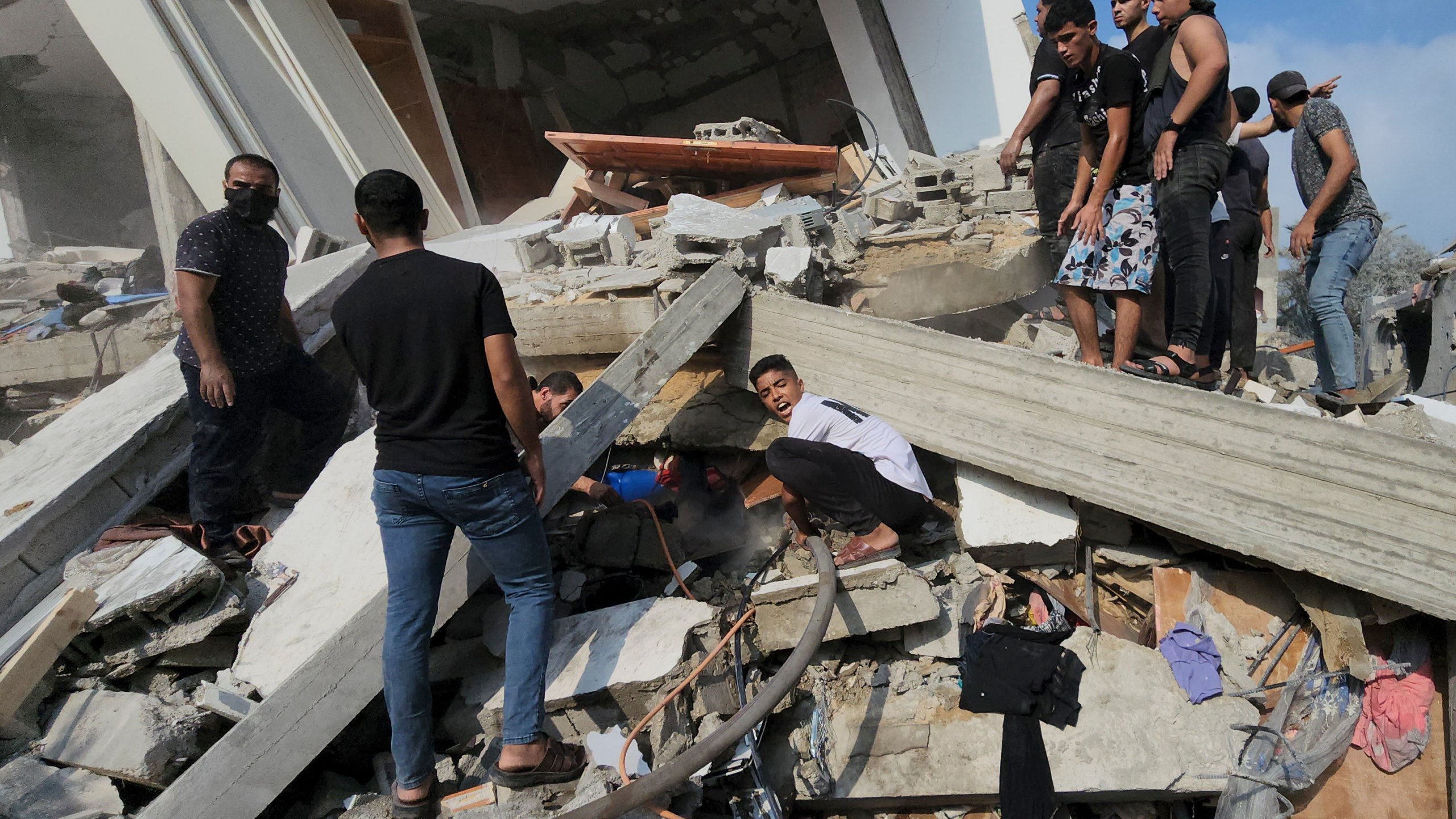 Palestinians look for survivors in the rubble of a destroyed building following an Israeli airstrike in Bureij refugee camp, Gaza Strip, Thursday, Nov. 2, 2023. (AP Photo/Hassan Eslaiah)