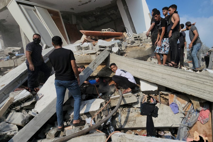 Palestinians look for survivors in the rubble of a destroyed building following an Israeli airstrike in Bureij refugee camp, Gaza Strip, Thursday, Nov. 2, 2023. (AP Photo/Hassan Eslaiah)