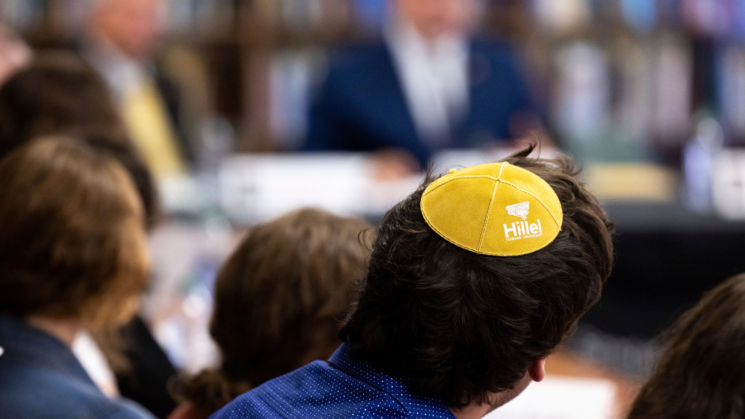 FILE - Samuel Winkler wears a Hillel kippah during a visit by Education Secretary Miguel Cardona to Towson University to discuss antisemitism on college campuses, Nov. 2, 2023, in Towson, Md. The Biden administration is warning U.S. schools and colleges that they must take immediate action to stop antisemitism and Islamophobia on their campuses, citing an “alarming rise” in threats and harassment. (AP Photo/Julia Nikhinson, File)