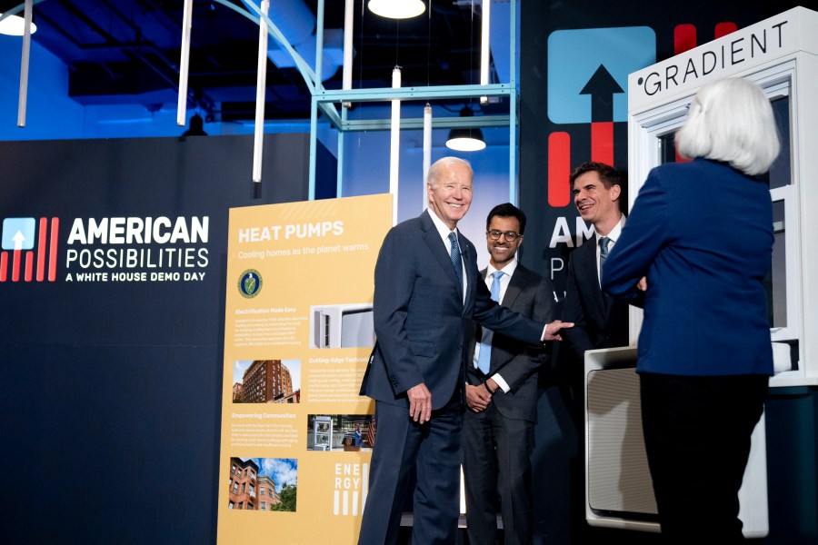 President Joe Biden laughs with Vincent Romanin, second from right, CEO of Gradient Comfort, a company that produces a window air conditioner with heat pump technology as he tours demonstrations during White House Demo Day, showcasing science and technology that have resulted from infrastructure investments, Tuesday, Nov. 7, 2023, at The Showroom in Washington. (AP Photo/Andrew Harnik)