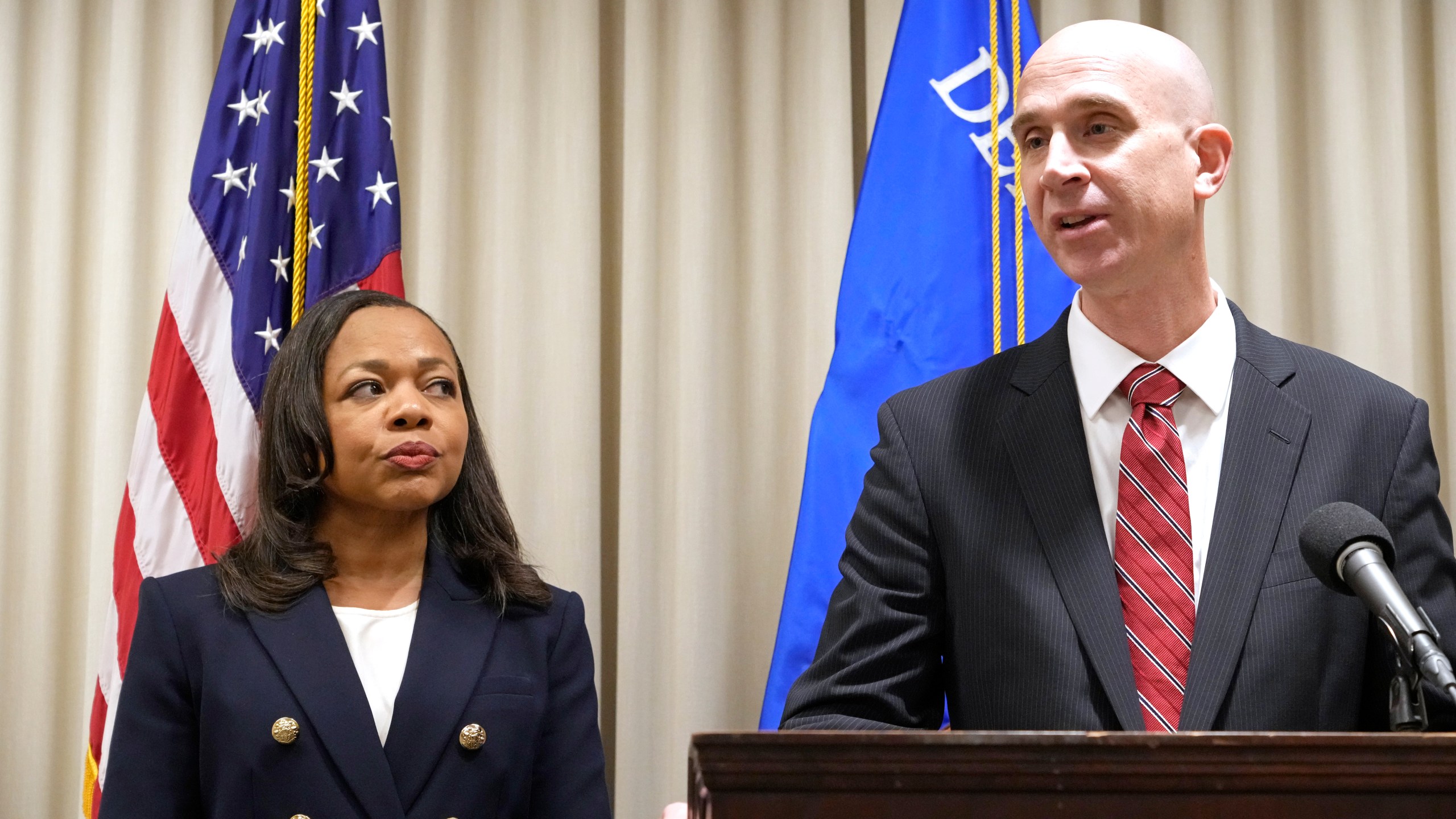 Assistant Attorney General Kristen Clarke of the U.S. Department of Justice Civil Rights Division, left, listens as U.S. Attorney Todd W. Gee for the Southern District of Mississippi, addresses a reporter's question during a news conference, Wednesday, Nov. 8, 2023, in Jackson, Miss., that it has opened an investigation into the City of Lexington, Miss., and the Lexington Police Department, focusing on the police department's use of force and its stops, searches and arrests. (AP Photo/Rogelio V. Solis)