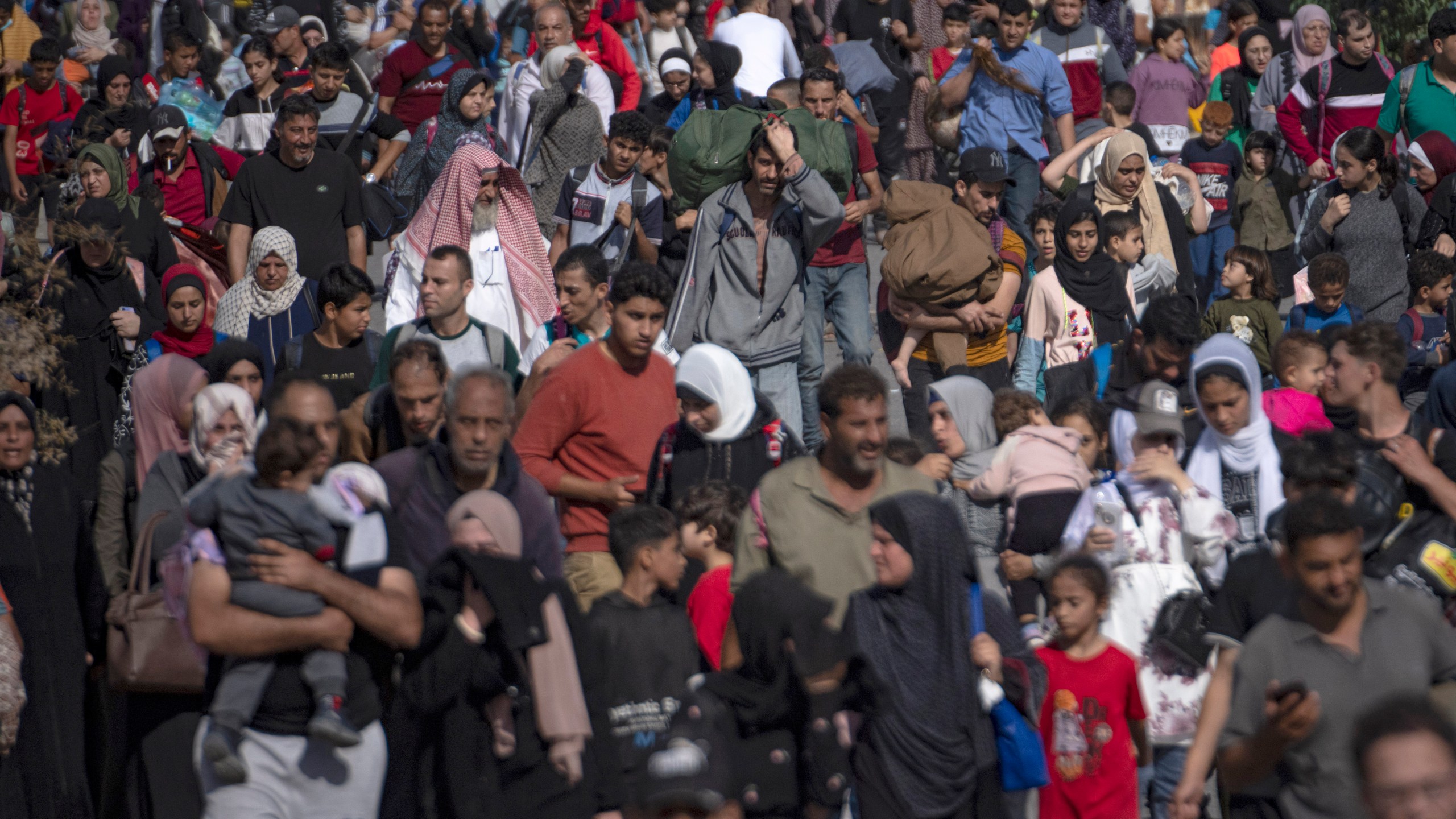 Palestinians flee to the southern Gaza Strip on Salah al-Din Street in Bureij, Gaza Strip, Friday, Nov. 10, 2023. (AP Photo/Fatima Shbair)