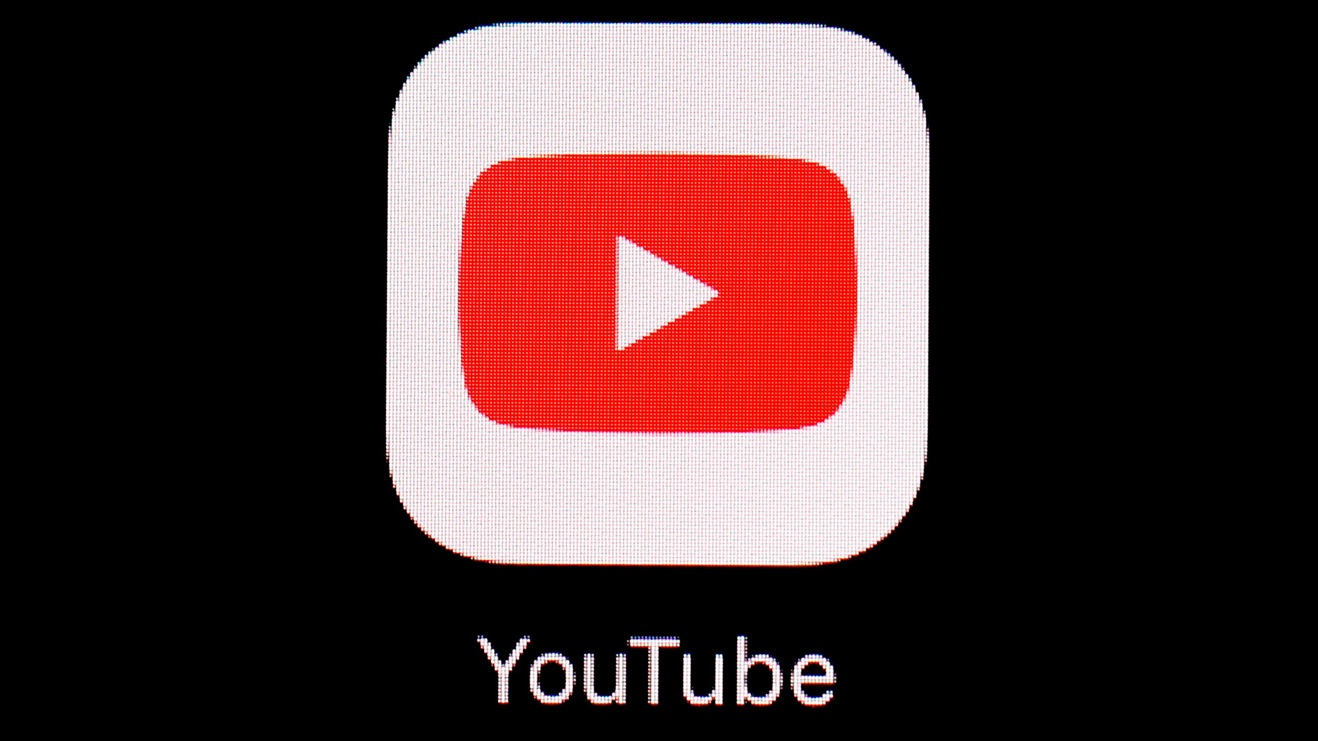 FILE - This March 20, 2018, file photo shows the YouTube app on an iPad in Baltimore. YouTube is rolling out new rules for AI content, Tuesday, Nov. 14, 2023, including requiring creators to reveal whether they've used generative artificial intelligence to make realistic looking videos. (AP Photo/Patrick Semansky, File)