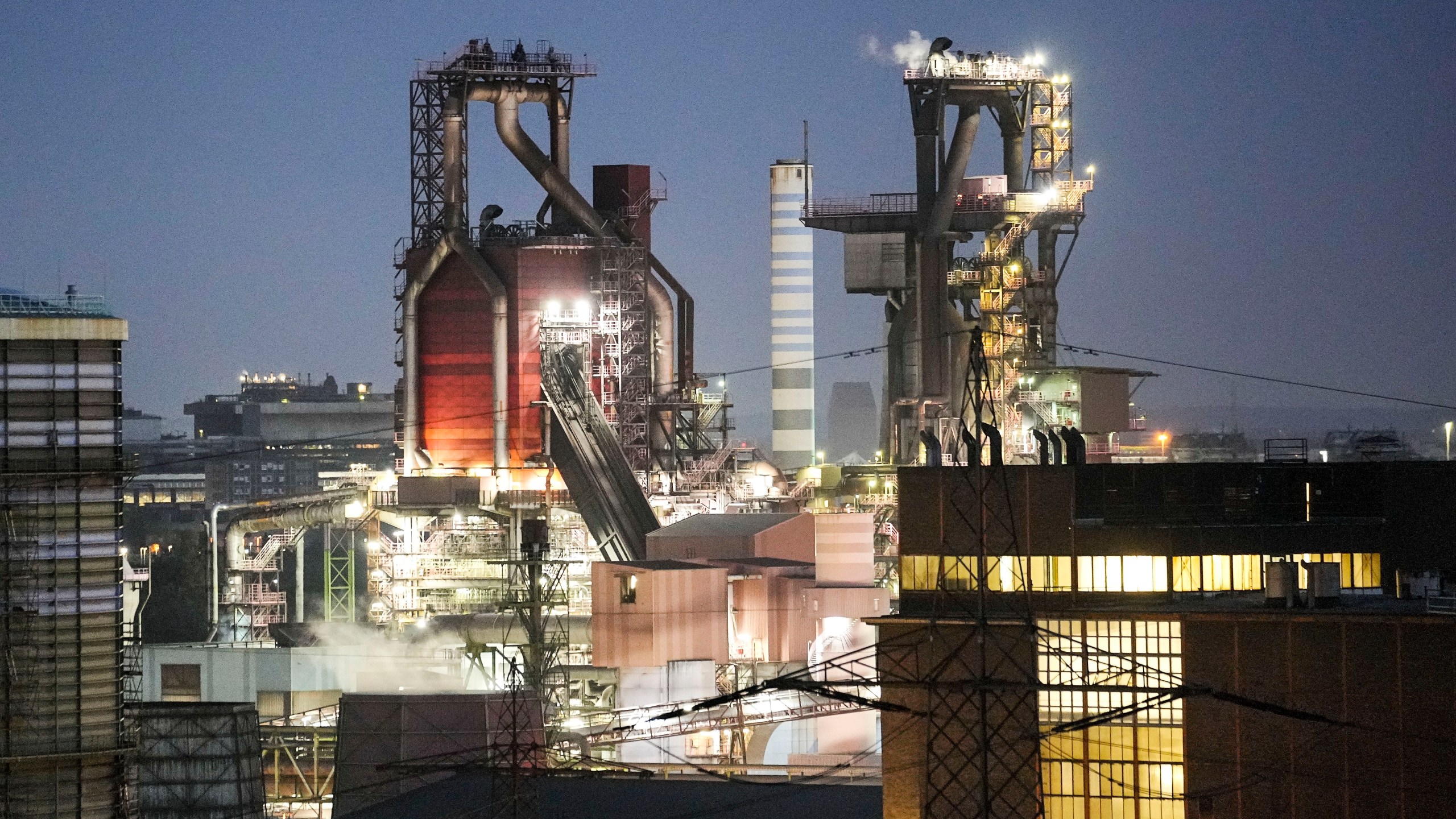 A blast furnace of German steel producer thyssenkrupp Steel Europe is in operation in the late evening in Duisburg, Germany, Wednesday, Oct. 11, 2023. The world is off track in its efforts to curb global warming, a new international report calculates Tuesday, Nov. 14. (AP Photo/Martin Meissner)