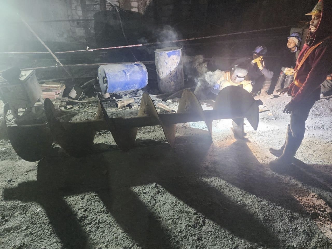 This photo provided by Uttarakhand State Disaster Response Force (SDRF) shows rescuers and others inside a collapsed road tunnel where 40 workers were trapped in northern in Uttarakhand state, India, Tuesday, Nov.14, 2023. ( SDRF via AP)