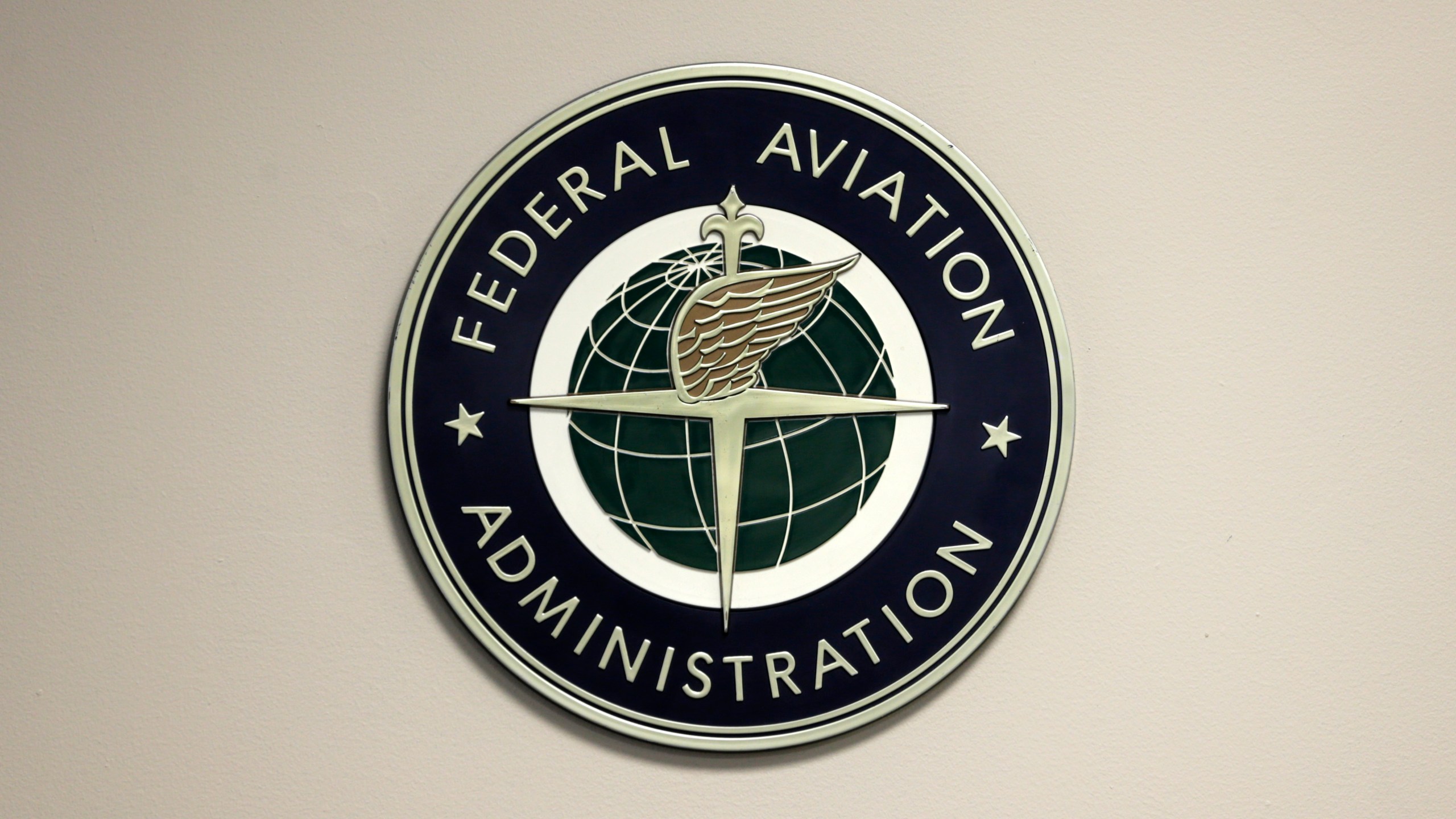 FILE - A Federal Aviation Administration sign hangs in the tower at John F. Kennedy International Airport, March 16, 2017, in New York. On Wednesday, Nov. 15, 2023, aviation experts who examined the FAA's safety record said the agency needs better staffing, equipment and technology to cope with a surge in the most serious close calls between planes. (AP Photo/Seth Wenig, File)