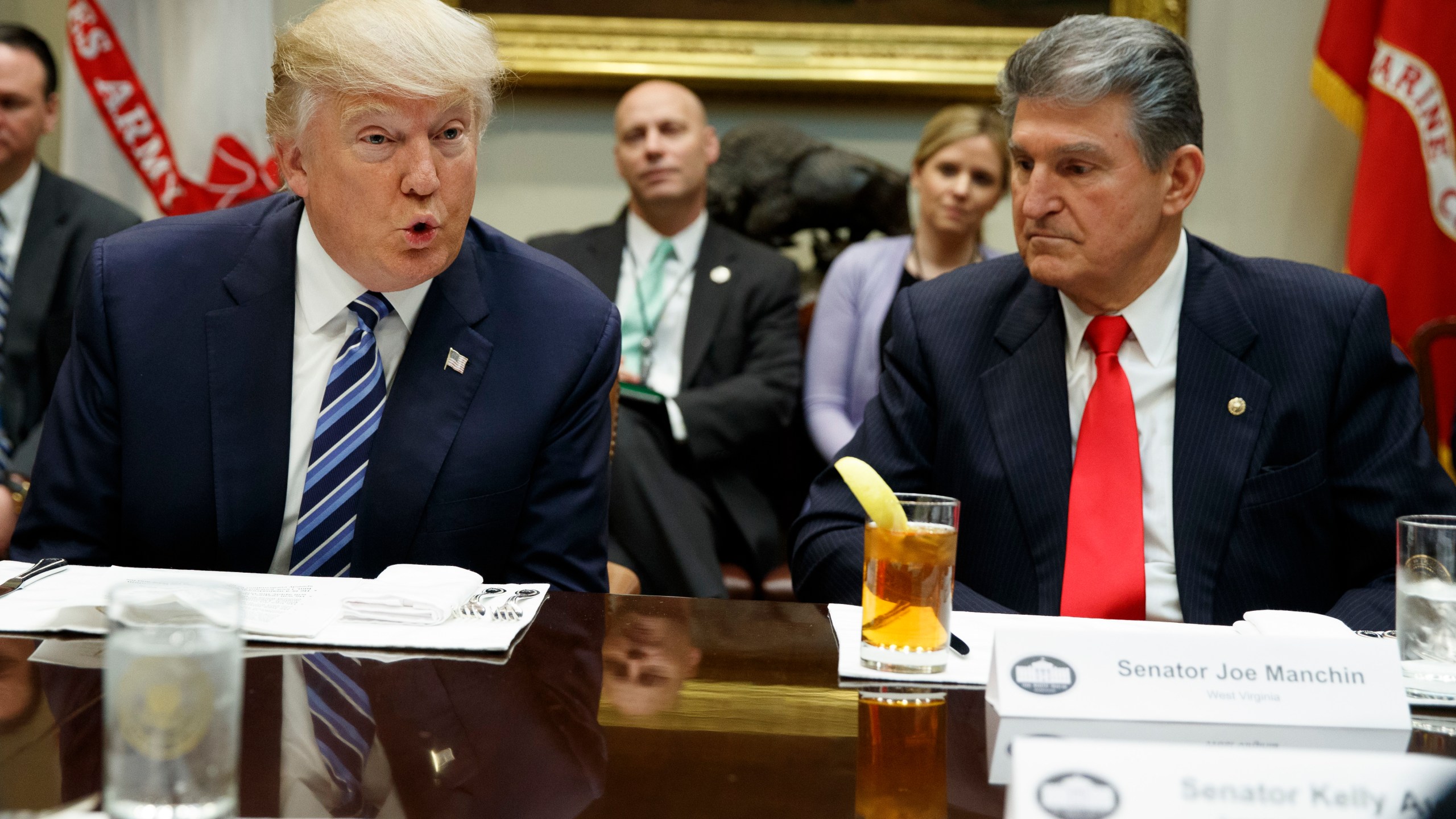 FILE - Sen. Joe Manchin, D-W.Va., right, listens at right as then-President Donald Trump speaks during a meeting with Senators on his Supreme Court Justice nominee Neil Gorsuch, Feb. 9, 2017, in the Roosevelt Room of the White House in Washington. Manchin said Wednesday, Nov. 15, 2023, that if voters give Trump another term in Washington, “he will destroy Democracy in America.” (AP Photo/Evan Vucci, File)