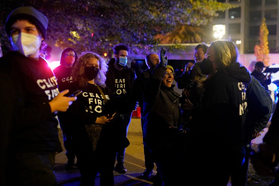 Protesters cheer outside the Democratic National Committee headquarters Wednesday, Nov. 15, 2023, in Washington. (AP Photo/Nathan Howard)