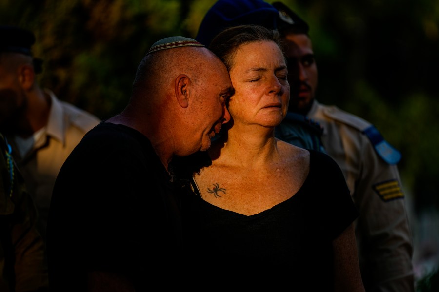 Doron and Tami, parents of Israeli reserve soldier captain Omri Yosef David mourn during his funeral in Carmiel, northern Israel, Wednesday, Nov. 15, 2023. David, 27, was killed during a military ground operation in the Gaza Strip. (AP Photo/Ariel Schalit)