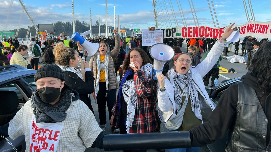 Demonstrators shout slogans after shuttting down the San Francisco Oakland Bay Bridge in conjunction with the APEC Summit taking place Thursday, Nov. 16, 2023, in San Francisco. (AP Photo/Noah Berger)