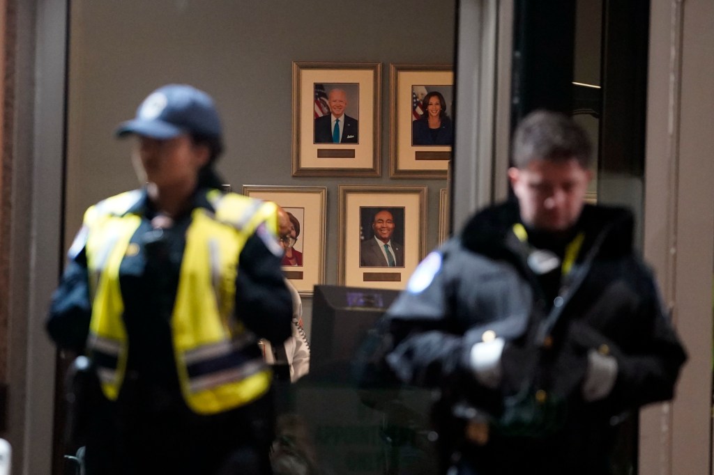 U.S. Capitol Police officers stand outside the headquarters of the Democratic National Committee Wednesday, Nov. 15, 2023, in Washington, after a protest. (AP Photo/Nathan Howard)