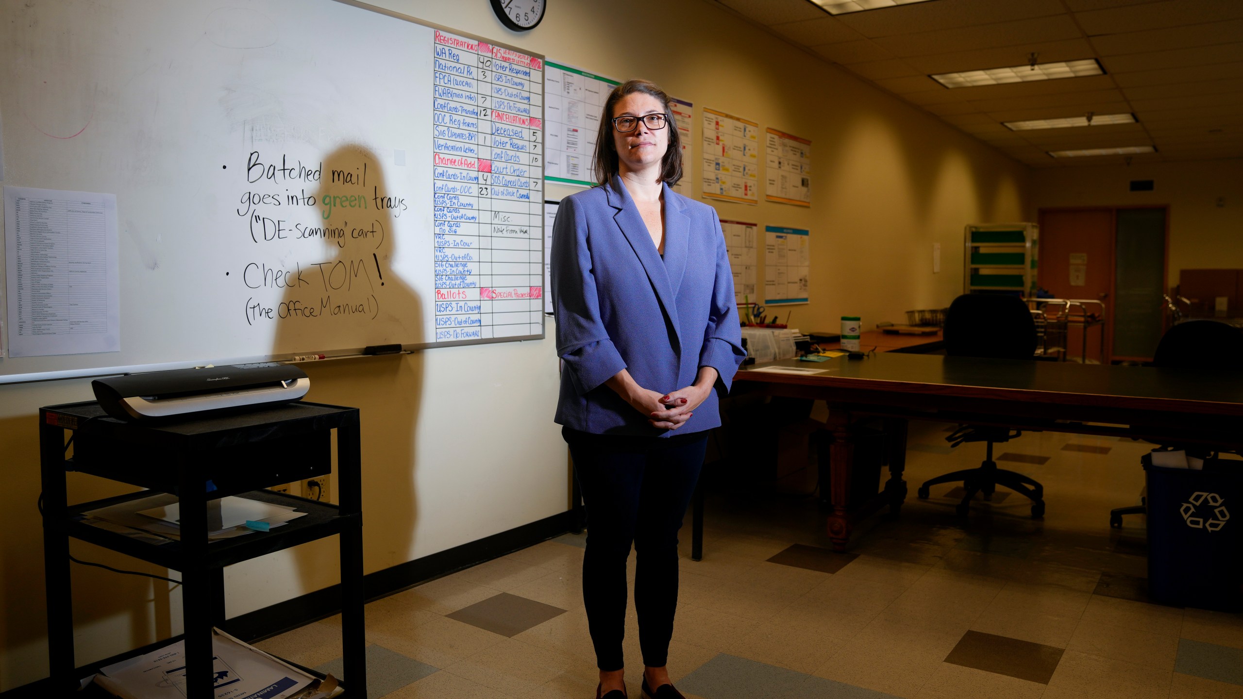 Halei Watkins, communications manager for King County Elections, poses for a portrait in the mail room at elections headquarters, Friday, Nov. 17, 2023, in Renton, Wash. The office began stocking Narcan, the nasal spray version of overdose-reversal drug naloxone, after receiving a letter laced with fentanyl in the summer and was evacuated the day after Election Day after receiving a similar envelope. (AP Photo/Lindsey Wasson)