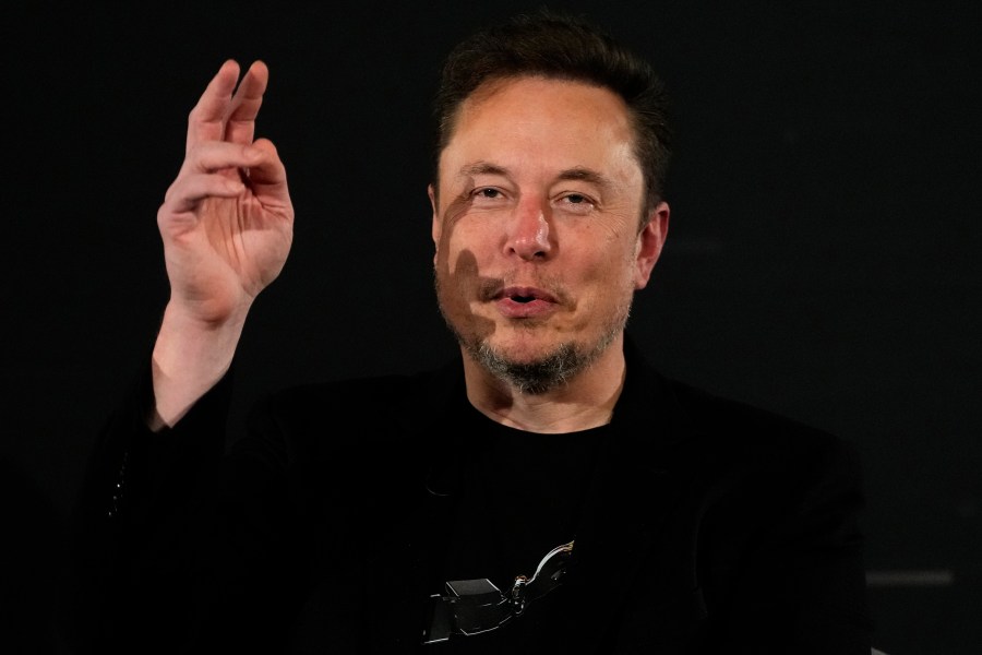 File - Elon Musk, owner of social media platform X, gestures during an event with Britain's Prime Minister Rishi Sunak in London on Nov. 2, 2023. IBM has stopped advertising on X after a report said its ads were appearing alongside material praising Adolf Hitler and Nazis. (AP Photo/Kirsty Wigglesworth, Pool, File)