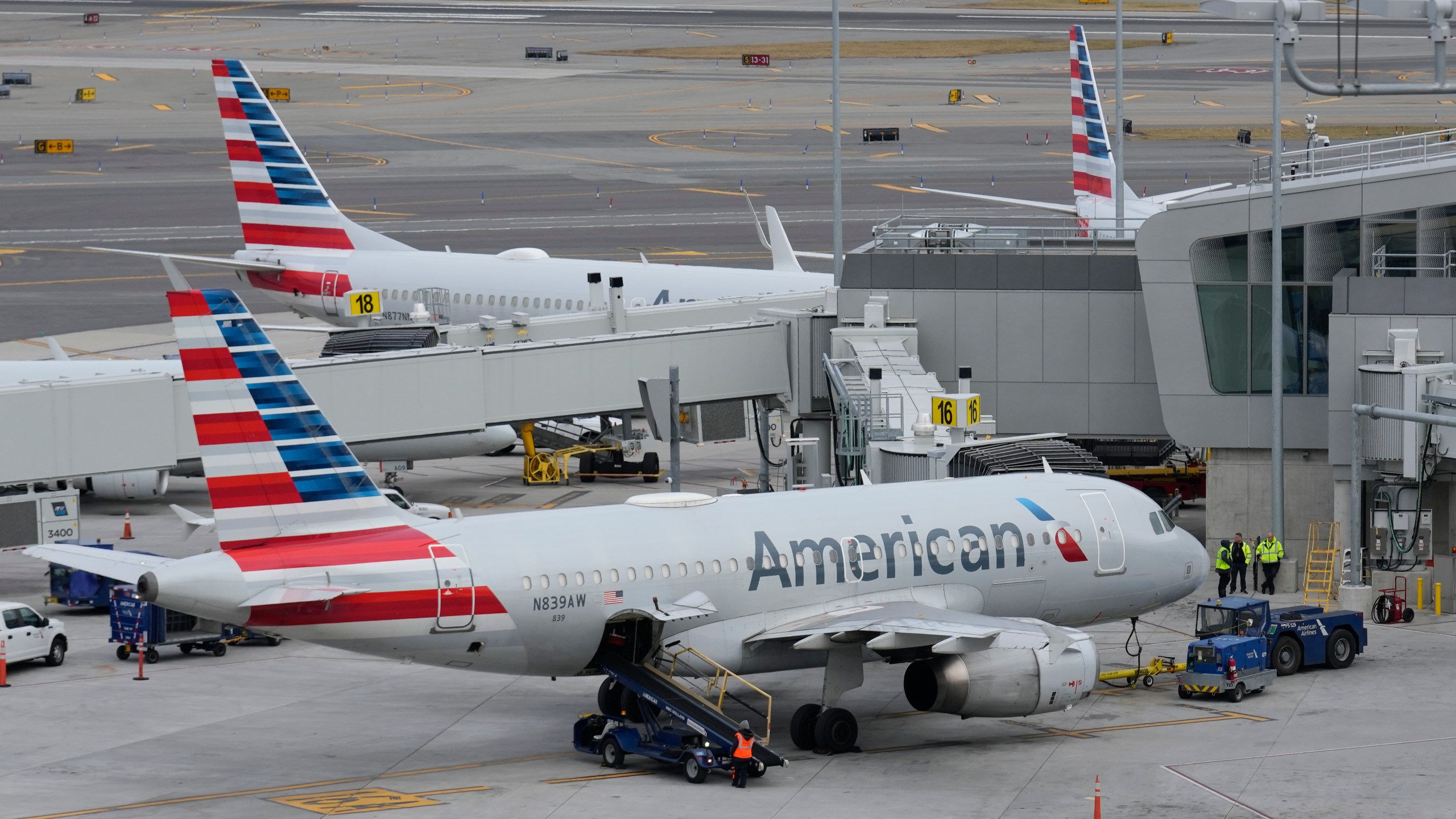 FILE - American Airlines planes sit on the tarmac at Terminal B at LaGuardia Airport, Jan. 11, 2023, in New York. American Airlines flight attendants are asking federal officials for the right to go on strike, possibly before the end of the Christmas and New Year's travel rush, but the airline said there was “no possibility” of a walkout over the holidays. The Association of Professional Flight Attendants petitioned the National Mediation Board on Monday, Nov. 20, to declare the negotiations deadlocked and give the union permission to strike after a 30-day “cooling-off period.” (AP Photo/Seth Wenig, File)