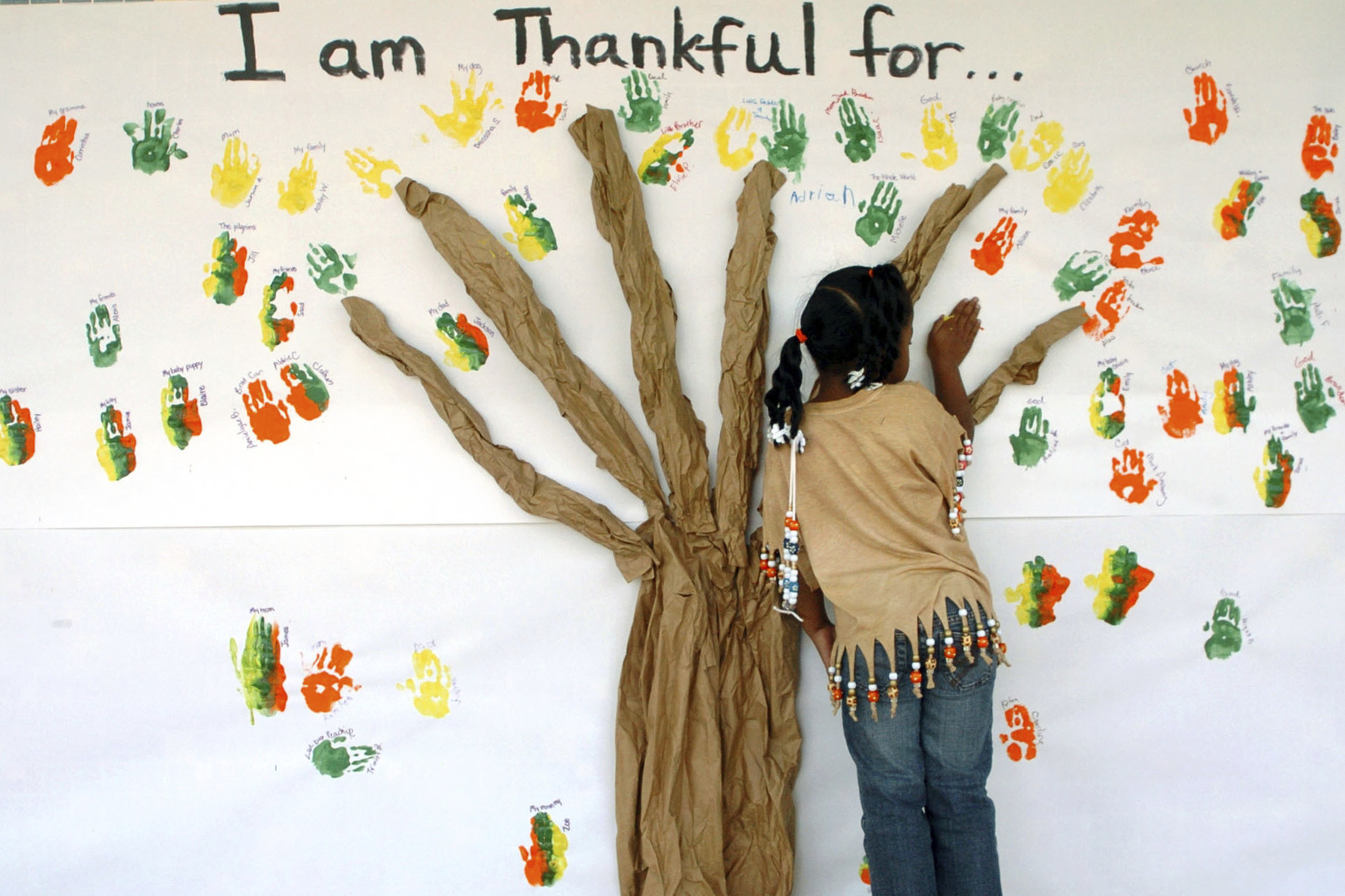 FILE - A student places her handprint along with those of other students at a primary school in Lufkin, Texas on Tuesday, Nov. 22, 2005. (Joel Andrews/The Daily News via AP, File)