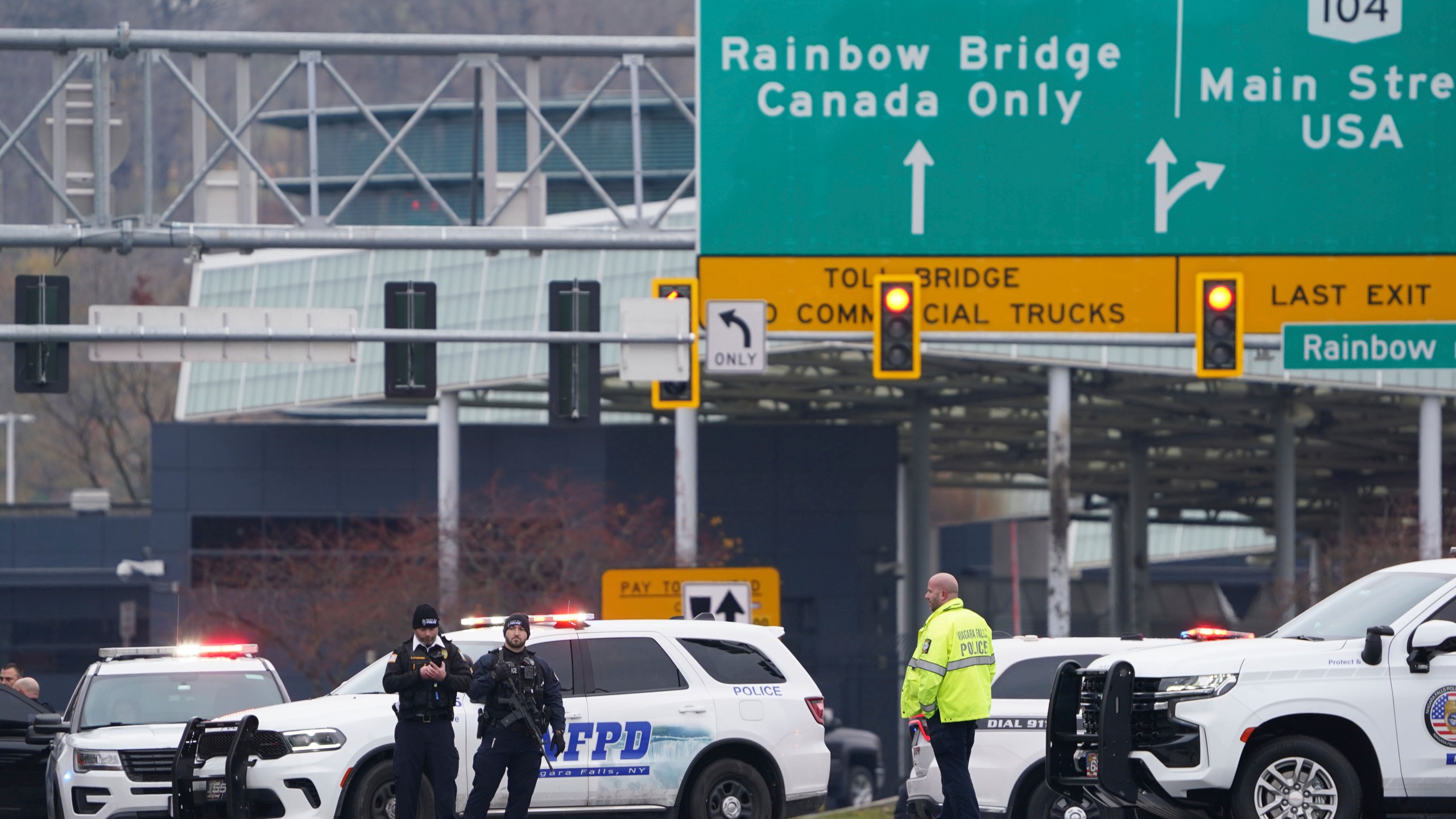 Law enforcement personnel block off the entrance to the Rainbow Bridge, Wednesday, Nov. 22, 2023, in Niagara Falls, N.Y. The border crossing between the U.S. and Canada has been closed after a vehicle exploded at a checkpoint on a bridge near Niagara Falls. The FBI's field office in Buffalo said in a statement that it was investigating the explosion on the Rainbow Bridge, which connects the two countries across the Niagara River. (Derek Gee/The Buffalo News via AP)