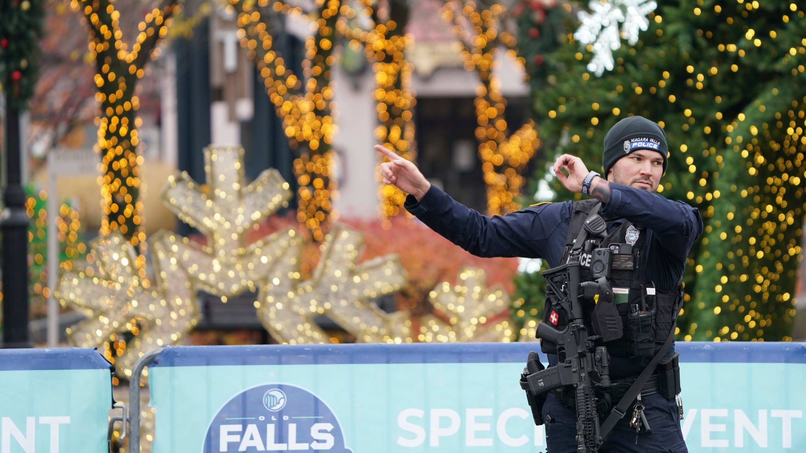 A Niagara Falls Police officer directs tourists in Niagara Falls, N.Y., away from the Rainbow Bridge border crossing after a car is reported to have exploded within the customs plaza, Wednesday, Nov. 22, 2023. (Derek Gee/The Buffalo News via AP)