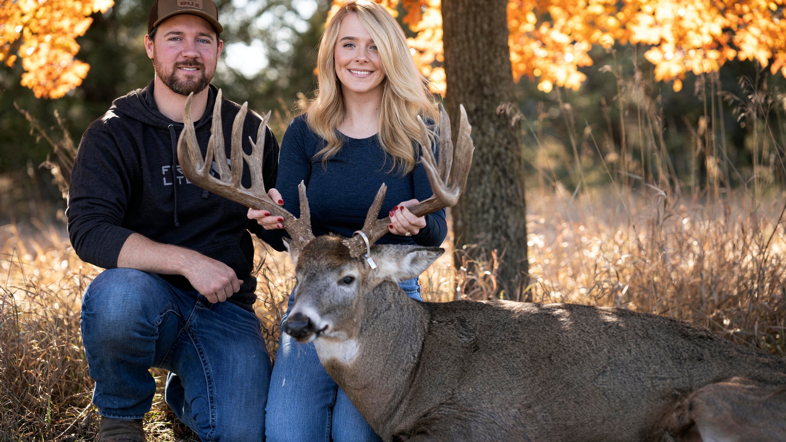 Cole Bures and Samantha Camenzind pose with the deer she shot near Filley, Neb., before he proposed to her on Nov. 12, 2023. Bures asked Camenzind to marry him during a photo shoot to commemorate the moment. (Brenton Lammers/Lammers Media via AP)