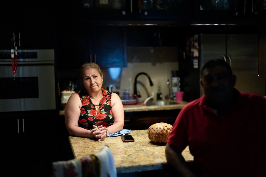 Rosalinda Ramirez, 57, and her partner Jose Guerrero, 41, Mexican immigrants who crossed the border separately over two decades ago and who have built lives and he a landscaping business in the U.S. but never found a route to obtain legal status, talk to AP journalists at their home in Homestead, Fla., Tuesday, Nov. 7, 2023. The couple are among those longterm immigrants in the U.S. who are frustrated to see newer arrivals getting work permits and government assistance, while they have paid taxes for decades without earning work permits, the ability to visit relatives back home and return, or freedom from the fear of deportation. (AP Photo/Rebecca Blackwell)