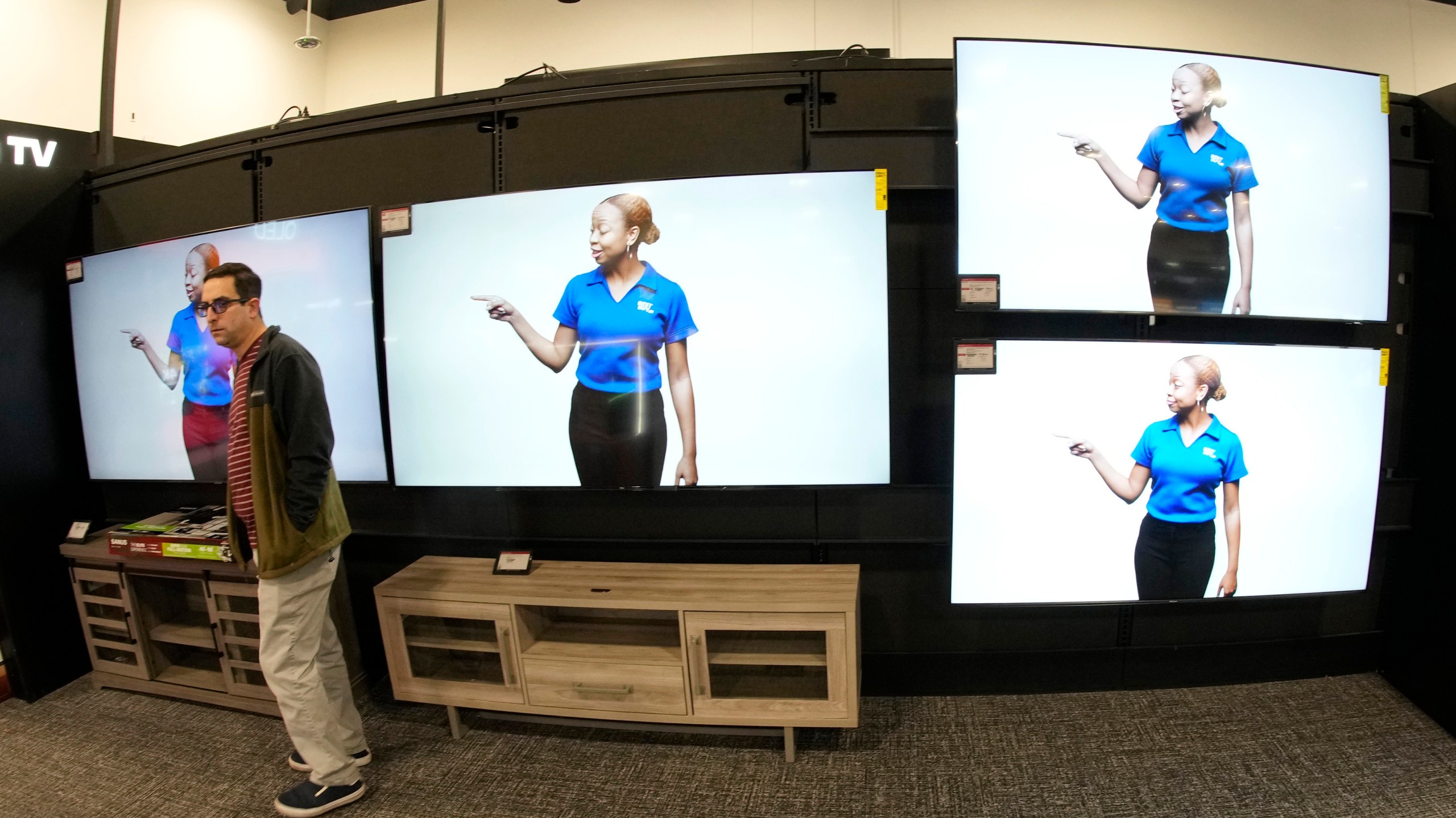 A customer turns away after looking at big-screen televisions on display in a Best Buy store Tuesday, Nov. 21, 2023, in southeast Denver. On Tuesday, the Conference Board reports on U.S. consumer confidence for November. (AP Photo/David Zalubowski)