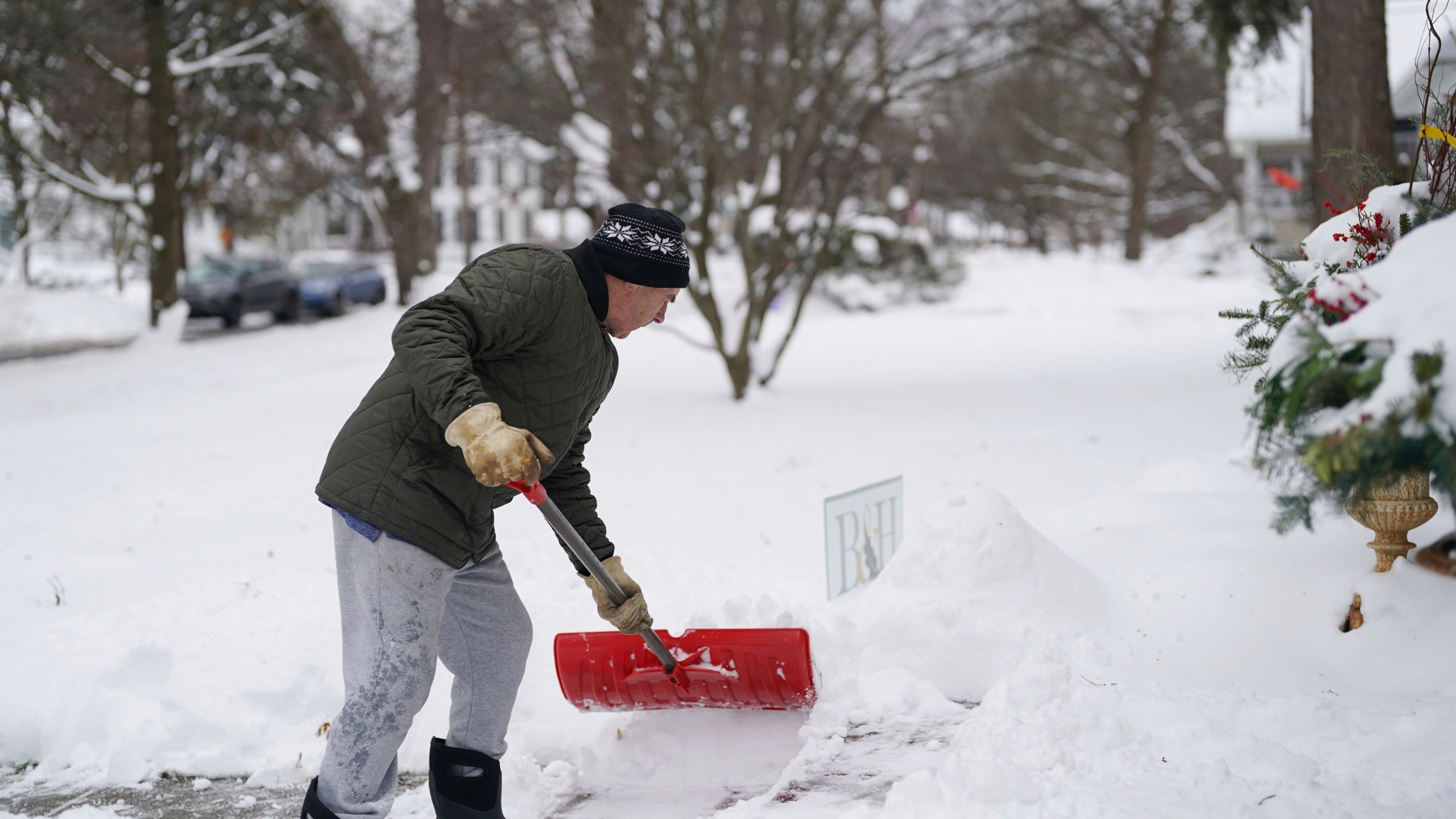 Jack Vickerd shovels his front sidewalk on Girard Avenue in East Aurora, N.Y. Tuesday, Nov. 28, 2023. (Derek Gee/The Buffalo News via AP)