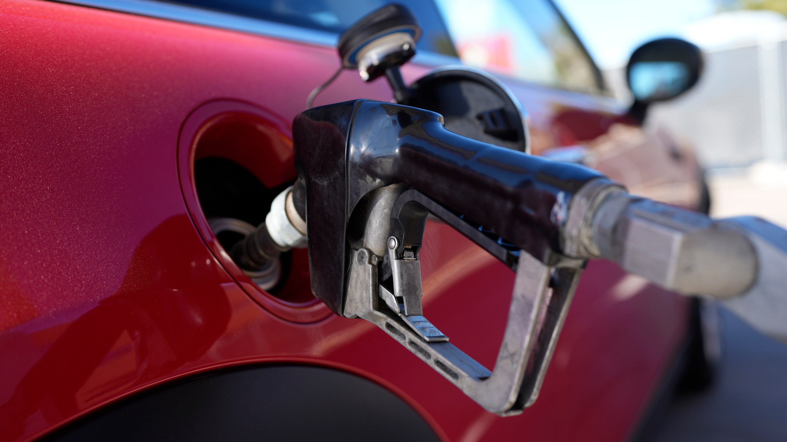 A motorist fills up the fuel tank of a vehicle at a Shell station Friday, Nov. 17, 2023, in Englewood, Colo. A big explanation for the recent decline in gas prices is seasonality — with prices at the pump almost always easing at this time of year. (AP Photo/David Zalubowski)