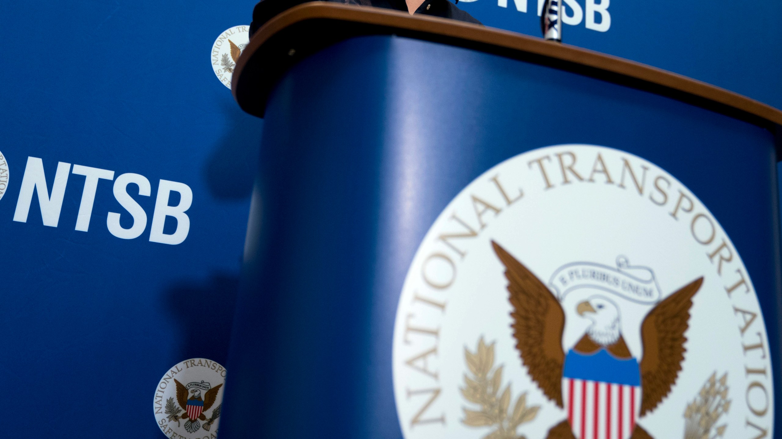 FILE - The National Transportation Safety Board logo and signage are seen at a news conference at NTSB headquarters in Washington, Dec. 18, 2017. The nation’s top accident investigator says a surge in close calls between planes at U.S. airports this year is a clear warning sign that aviation is under stress. Jennifer Homendy, chair of the National Transportation Safety Board, told a Senate panel Thursday, Nov. 8, 2023 that close calls are incredibly rare, but we cannot ignore the recent increase in such events. (AP Photo/Andrew Harnik, File)